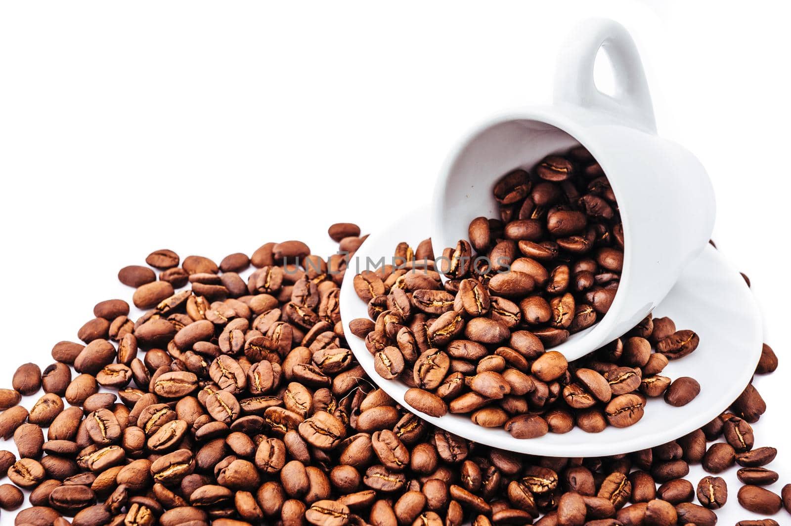 white cup with coffee beans isolated