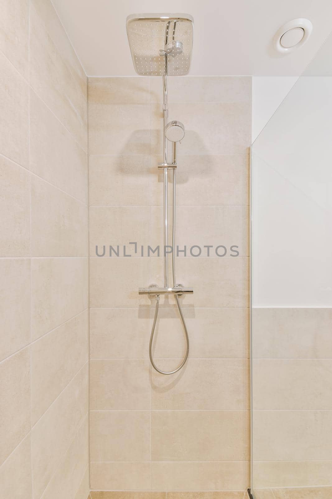 Bathroom interior finished with beige tiles by casamedia