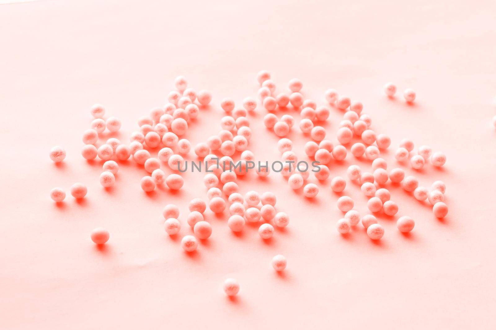 Romantic pattern of pink tinted beads scattered on a soft pink background, festive pattern for wedding design close-up. Hobby, craft and handmade theme by claire_lucia
