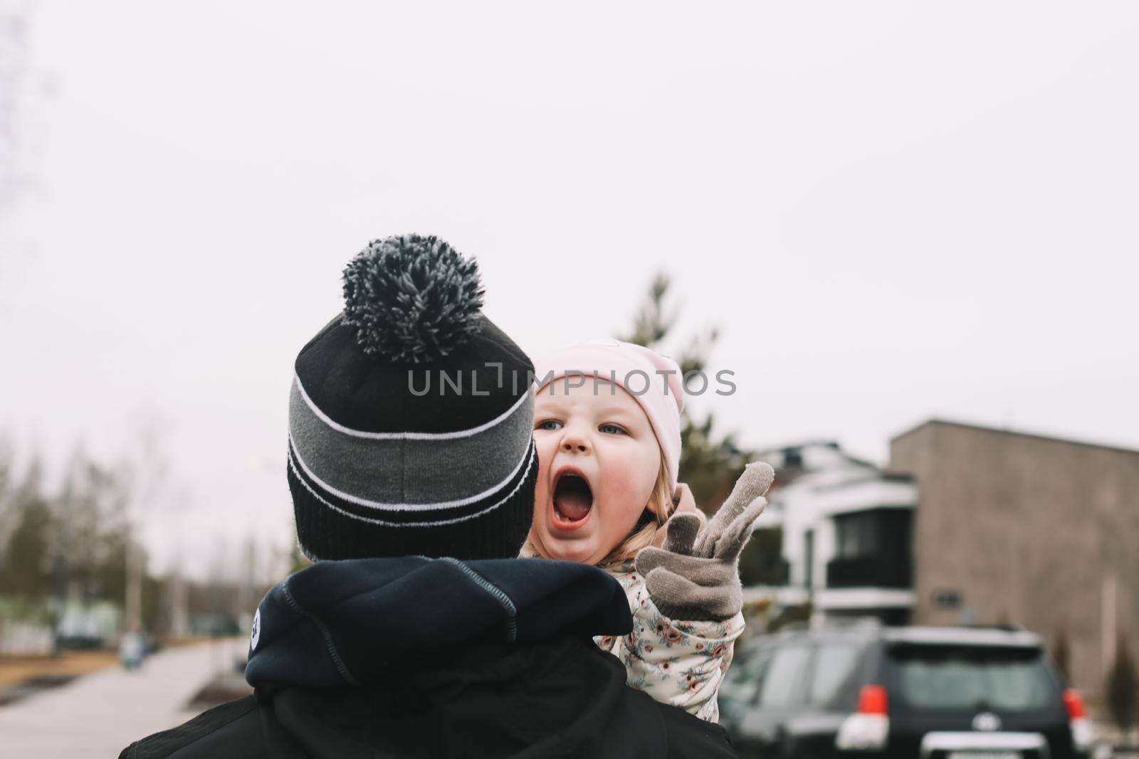 Happy emotional girl with father. Family having fun outdoors. Father and daughter together.