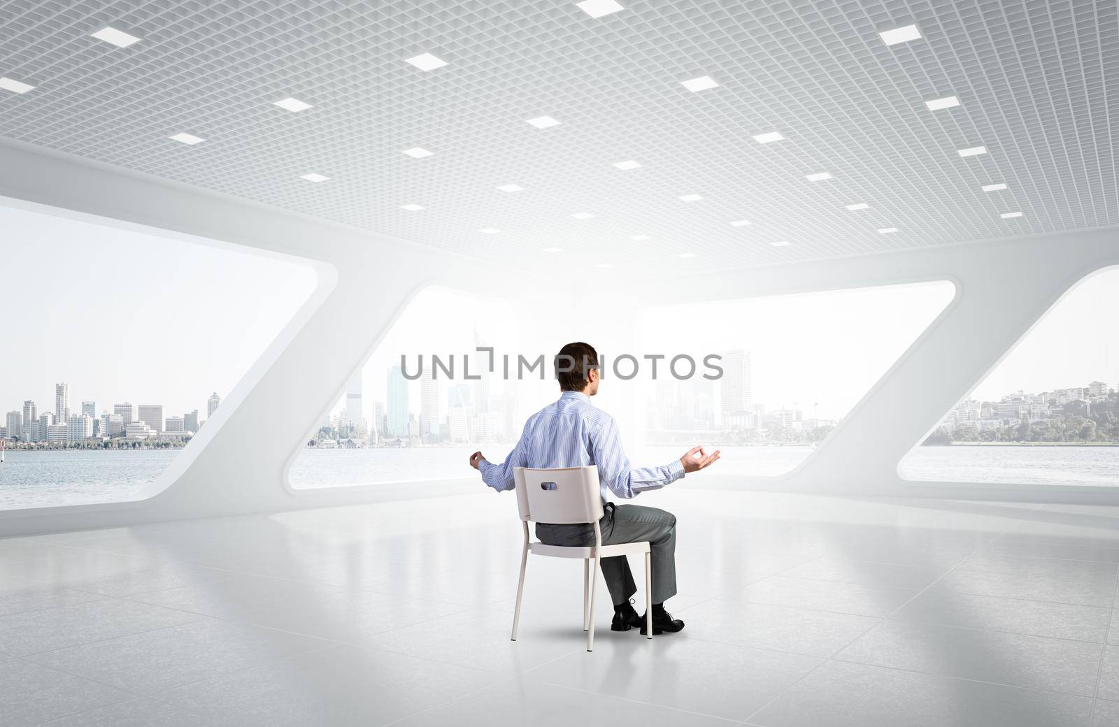 young businessman meditating in the office by adam121
