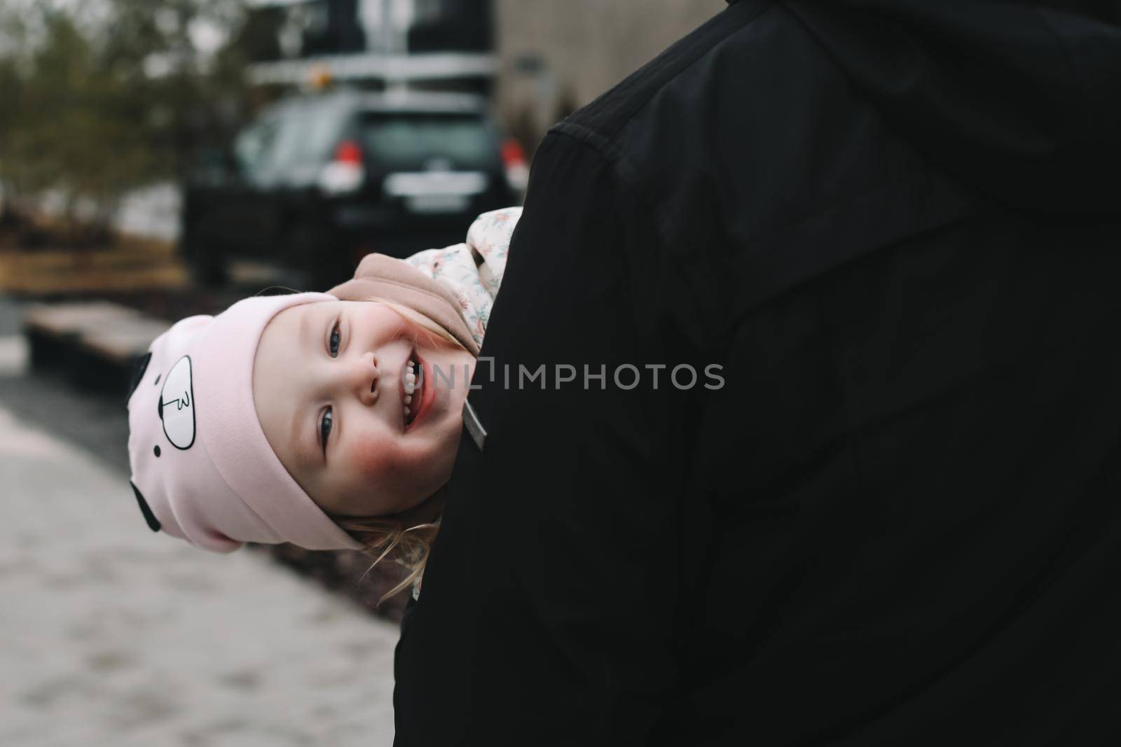 Happy emotional girl with father. Family having fun outdoors. Father and daughter together.