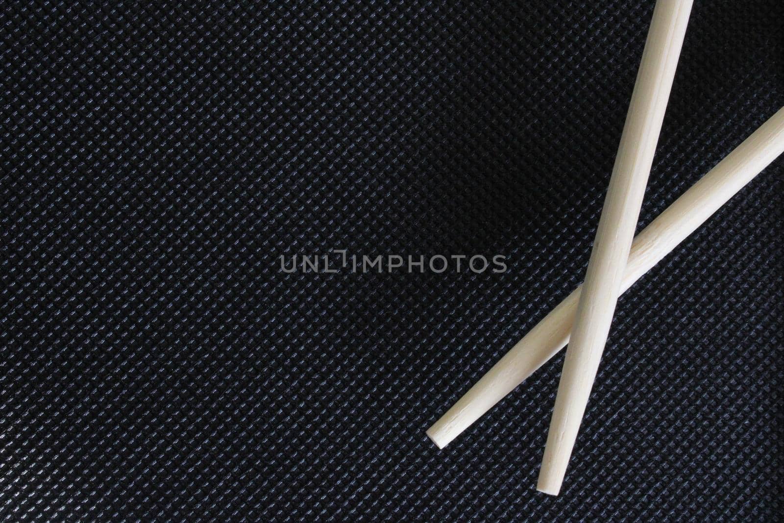 Sushi sticks on a black background with an empty space. The concept of food. Japanese cuisine. Background for websites, posters, postcards. High quality photo