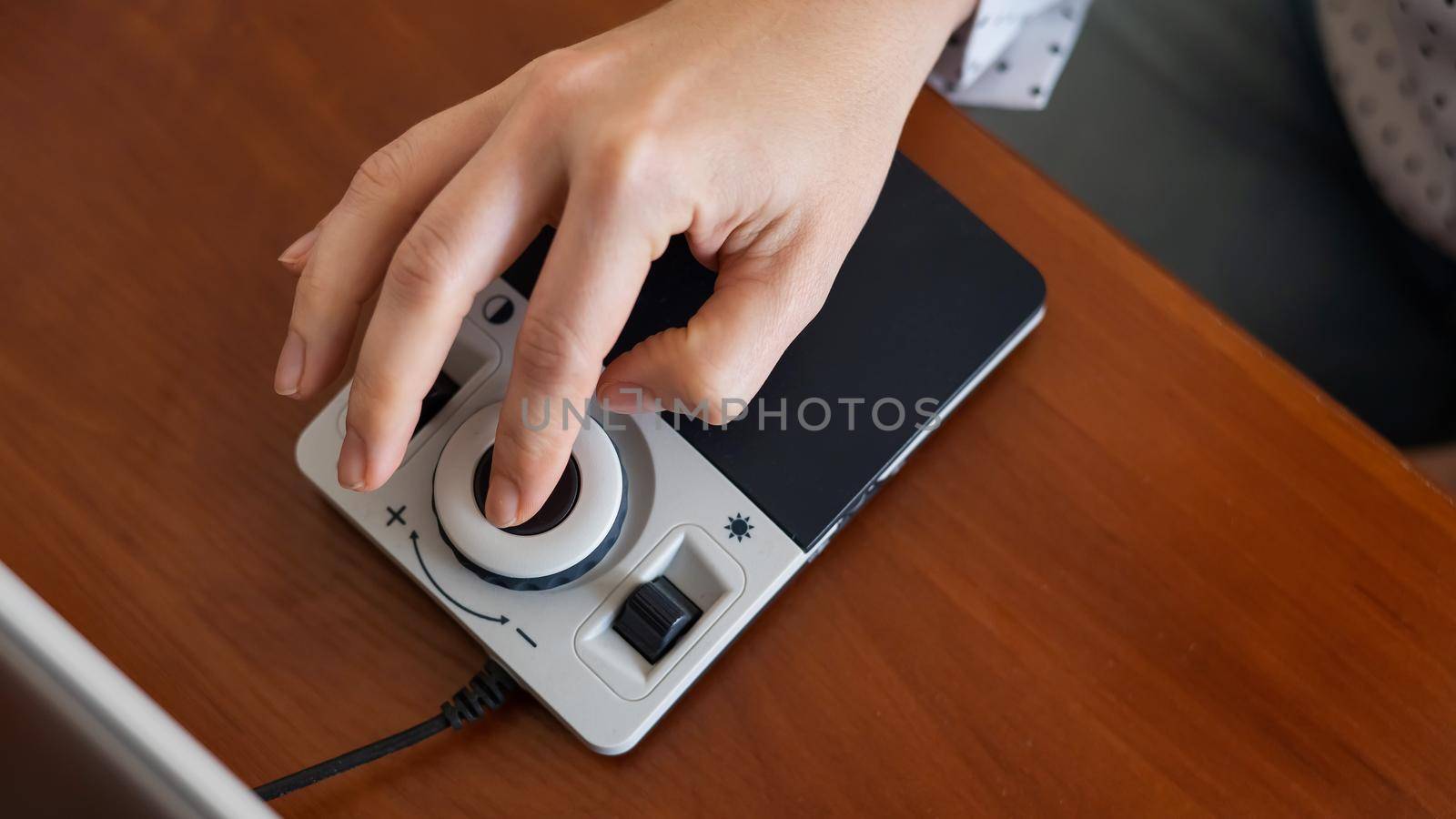 A woman uses a special magnification device for the visually impaired