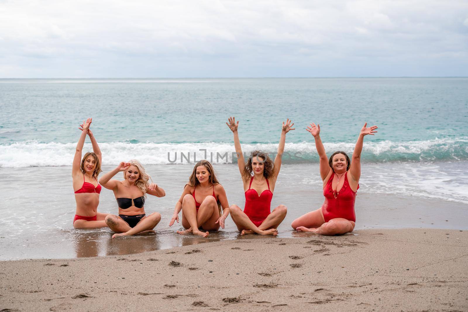 Big happy family or group of five friends is having fun against sunset beach. Beach holidays concept