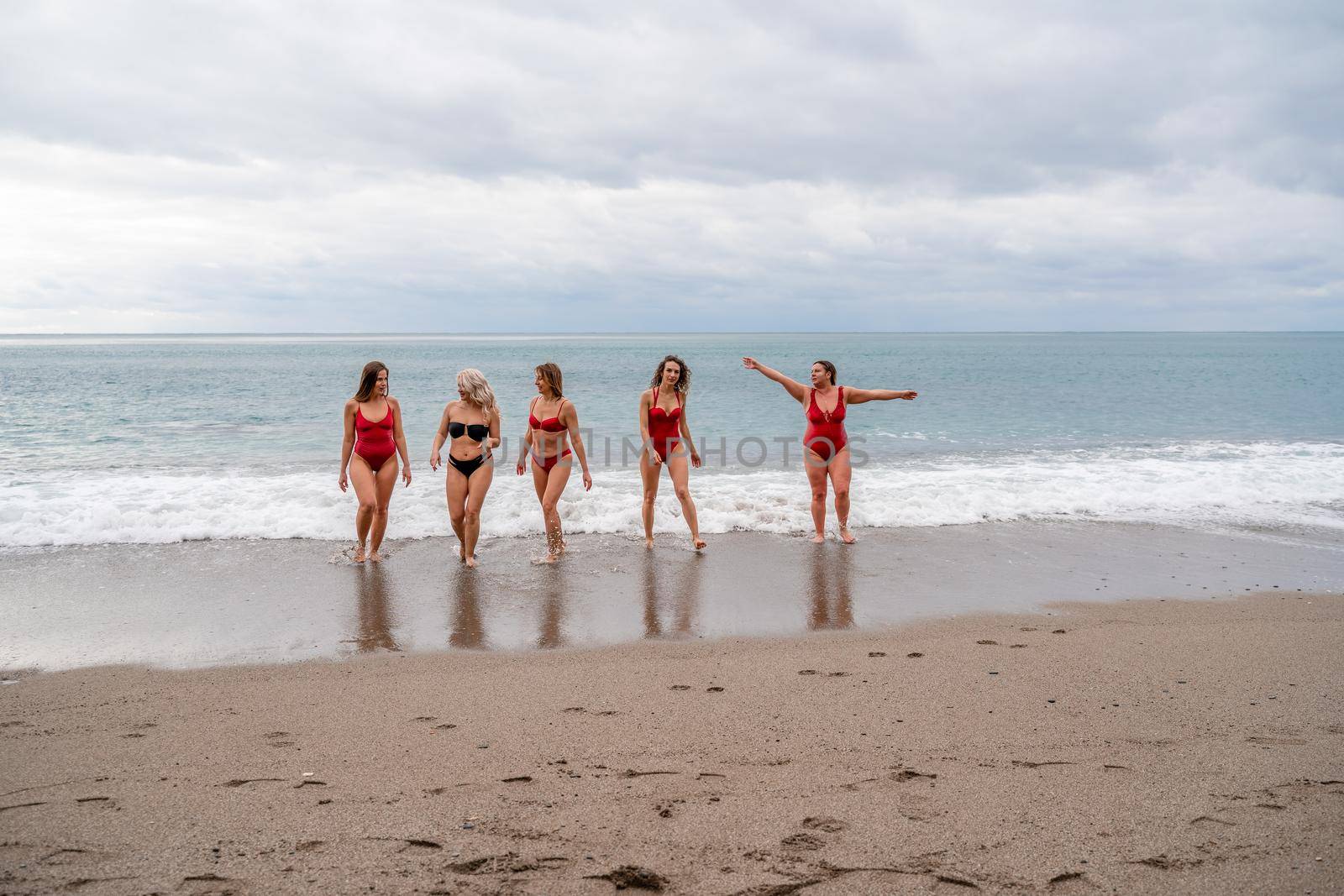 Big happy family or group of five friends is having fun against sunset beach. Beach holidays concept. by Matiunina