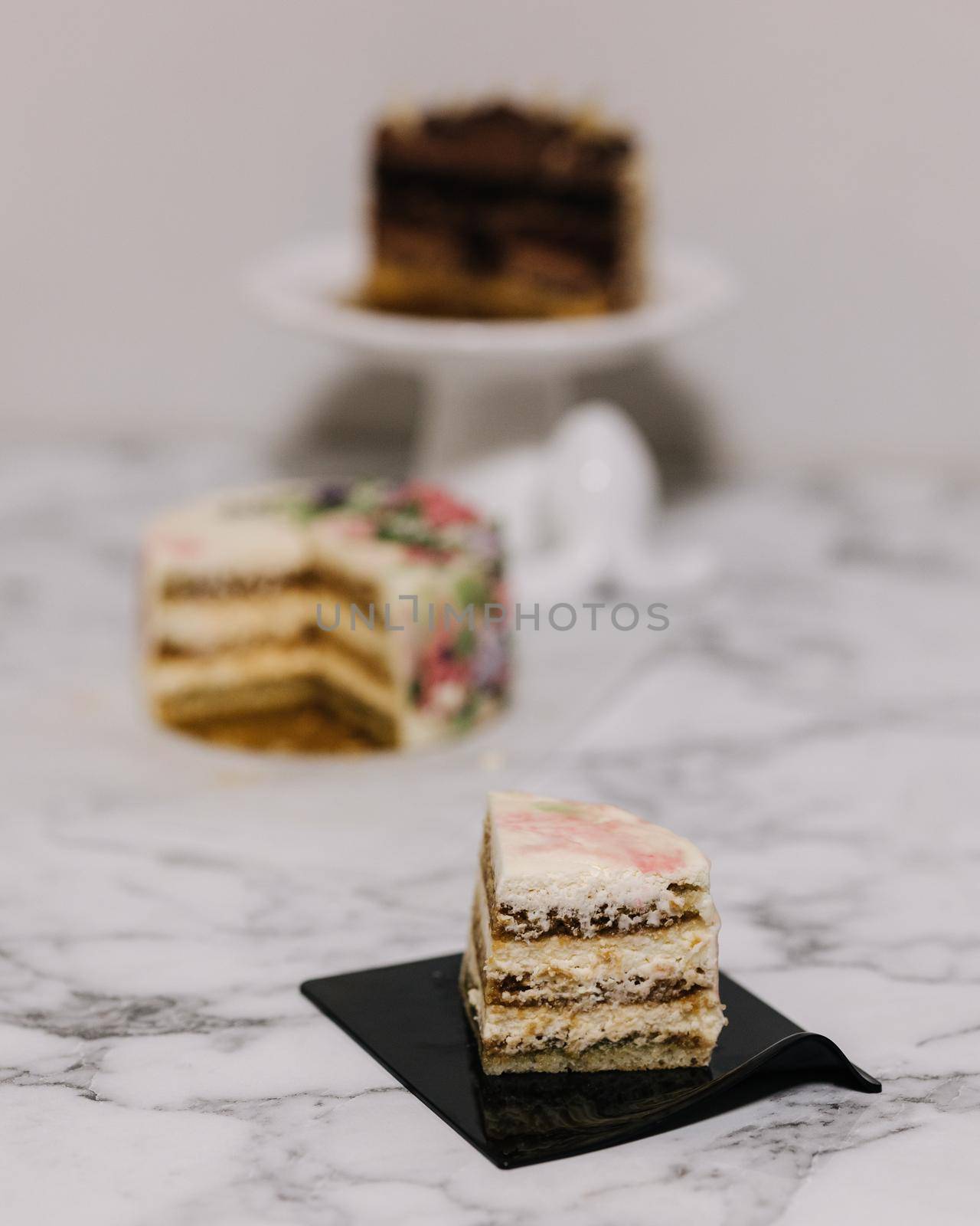 Slice of tiramisu bento cake. Presentation of cake in section. Sweet dessert for one person. Little birthday cake.