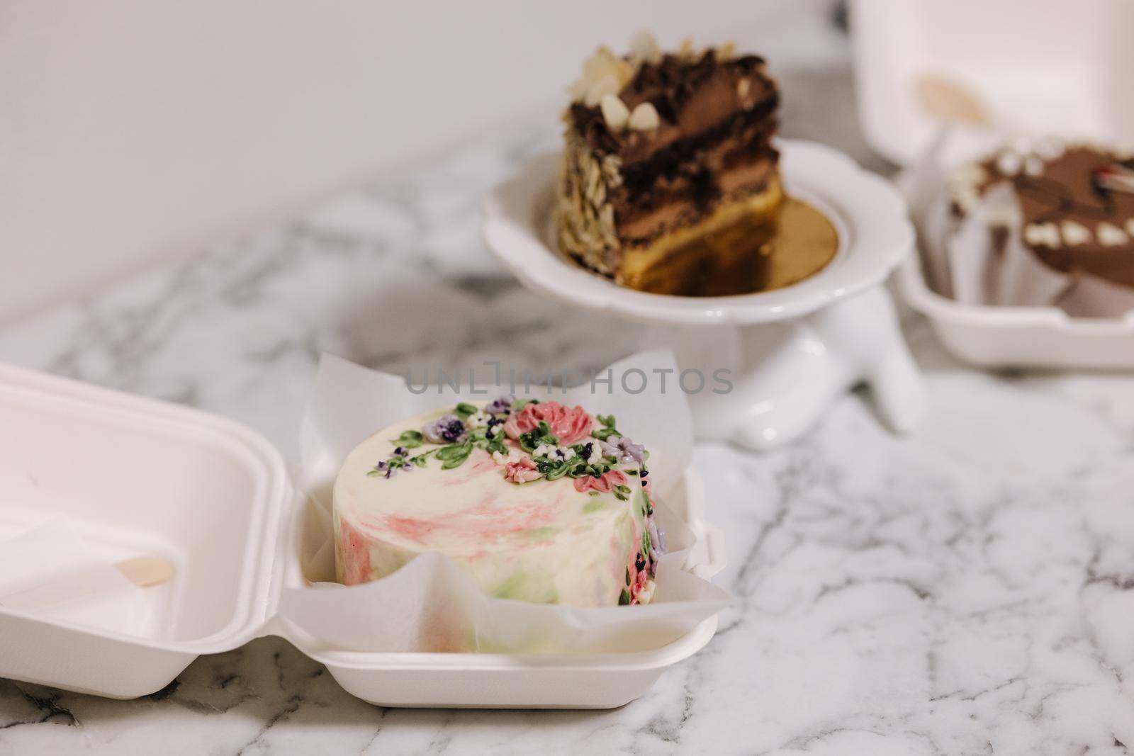 Three different bento cake on white table. Small bento cake for one person as a gift for the holiday.