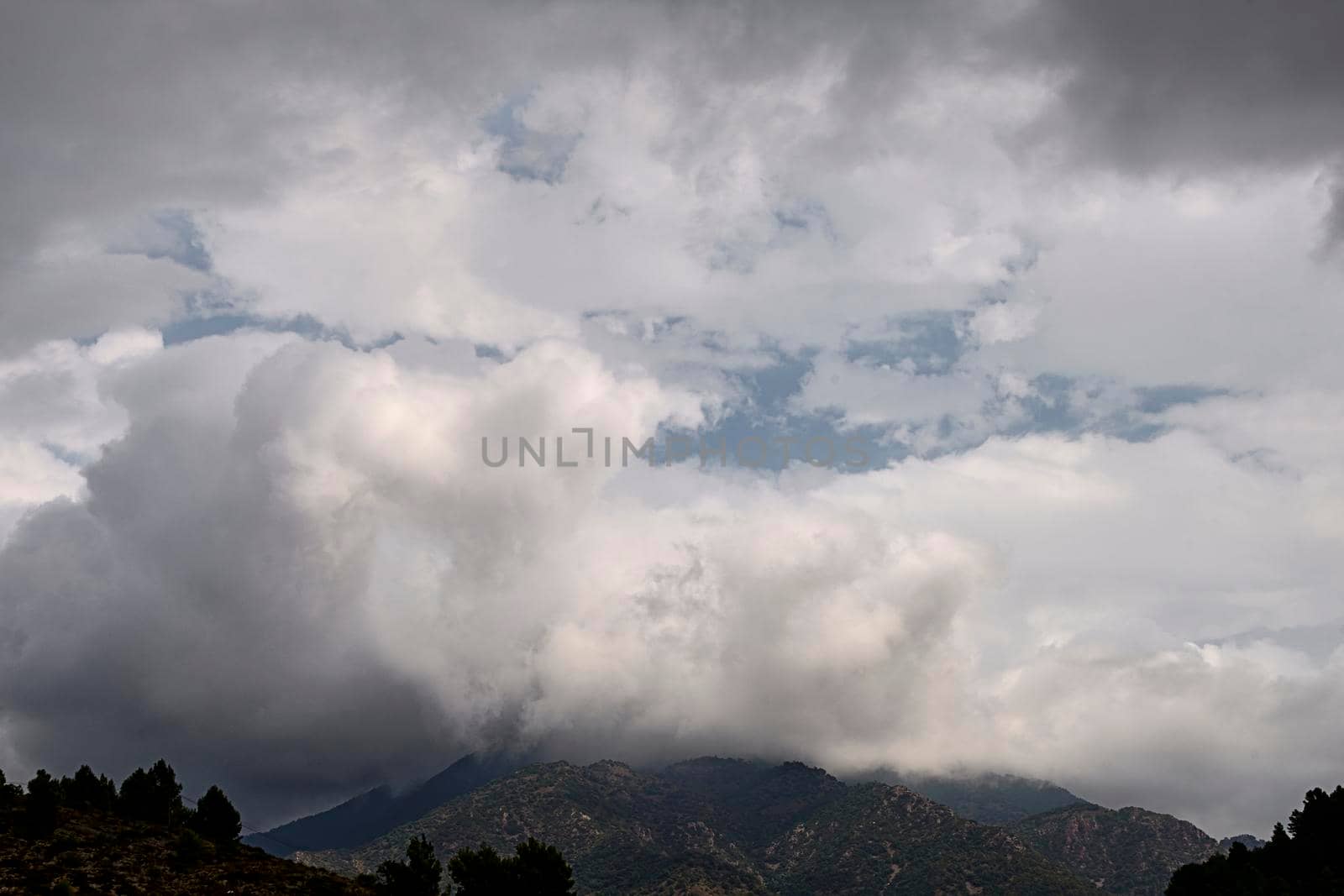 Mountain surrounded by large storm clouds, flog by raul_ruiz