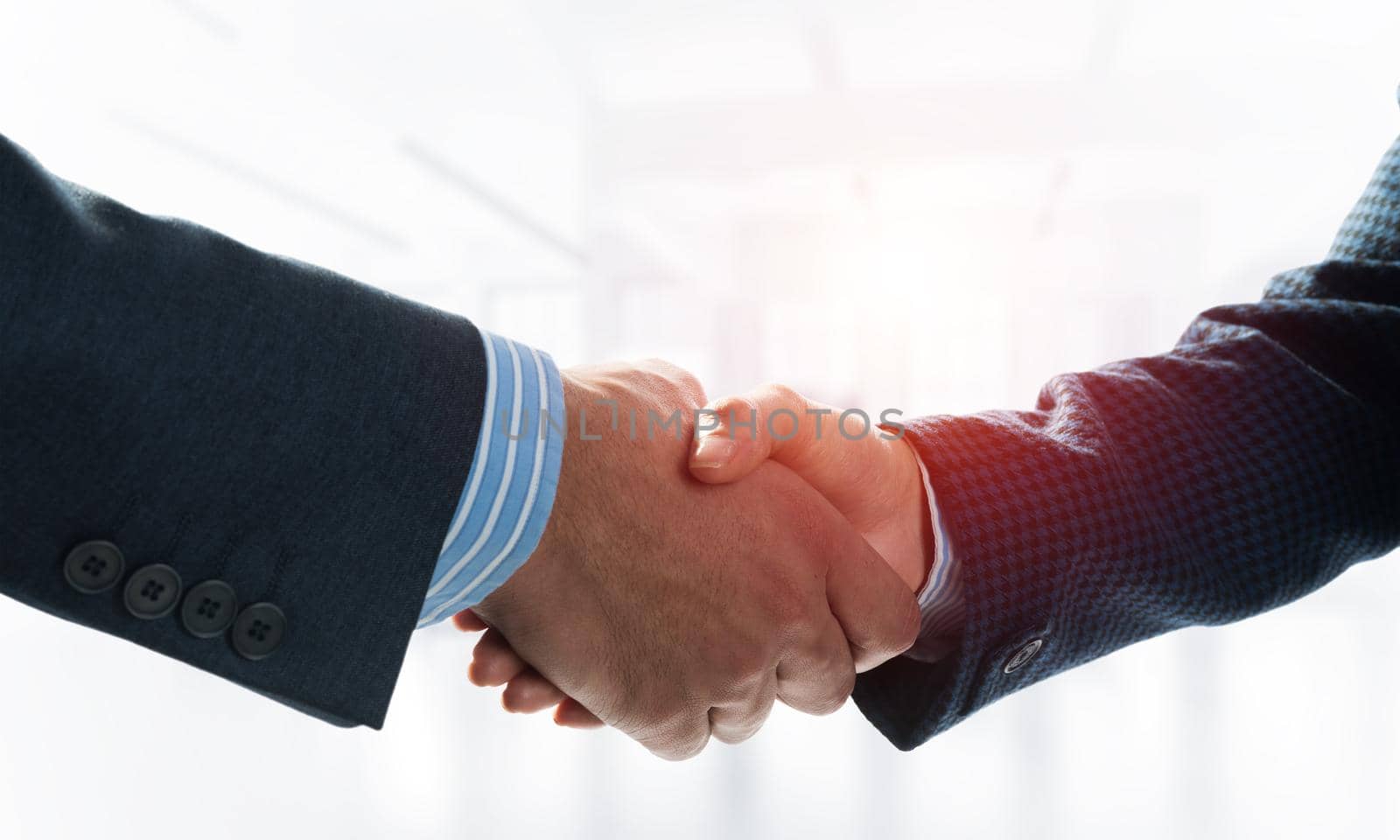 A close-up of a handshake. Making a deal between two businessmen