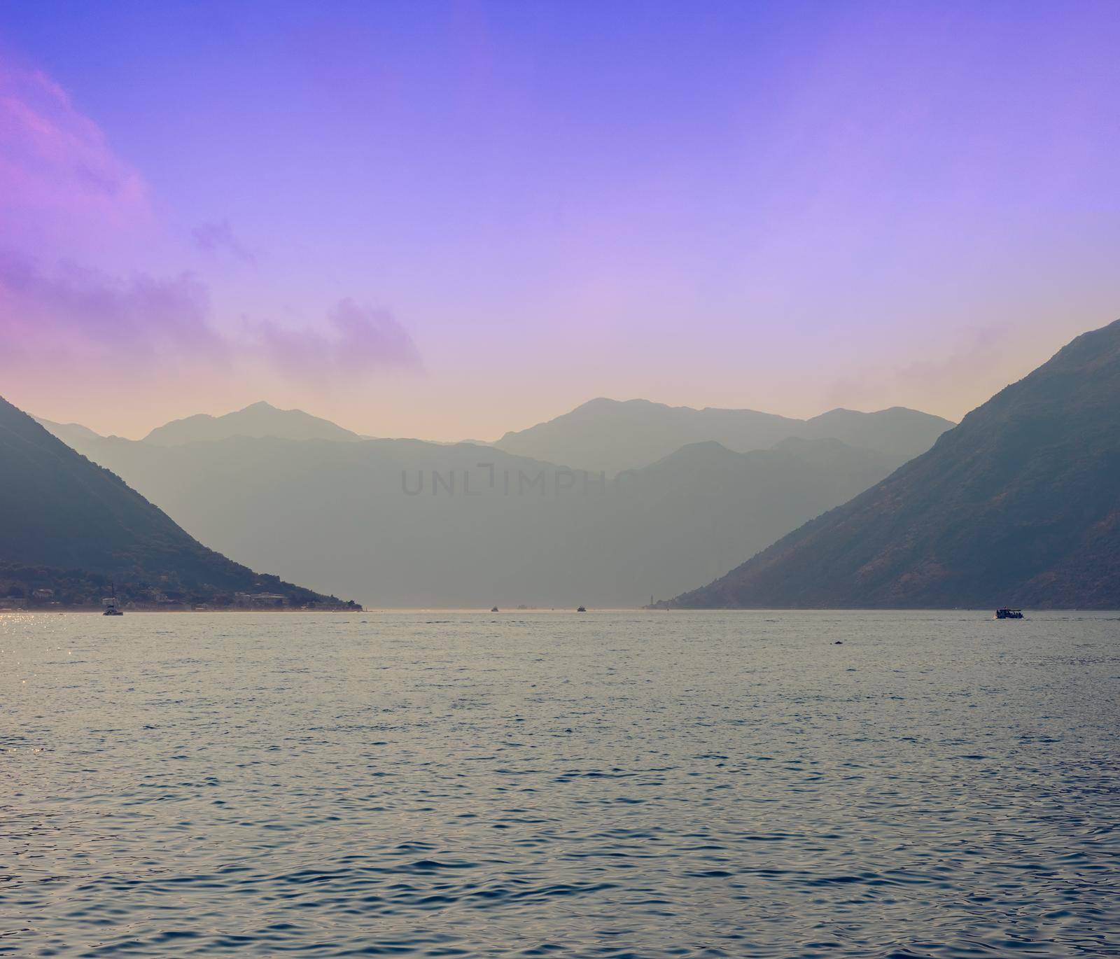 Sunset, beautiful landscape with silhouettes of trees. Travel concept. Montenegro, Kotor Bay. Sunset at Kotor Bay Montenegro. View of the sunset in Boko-Kotor Bay in Montenegro. Silhouettes of mountains. High quality photo by Andrii_Ko