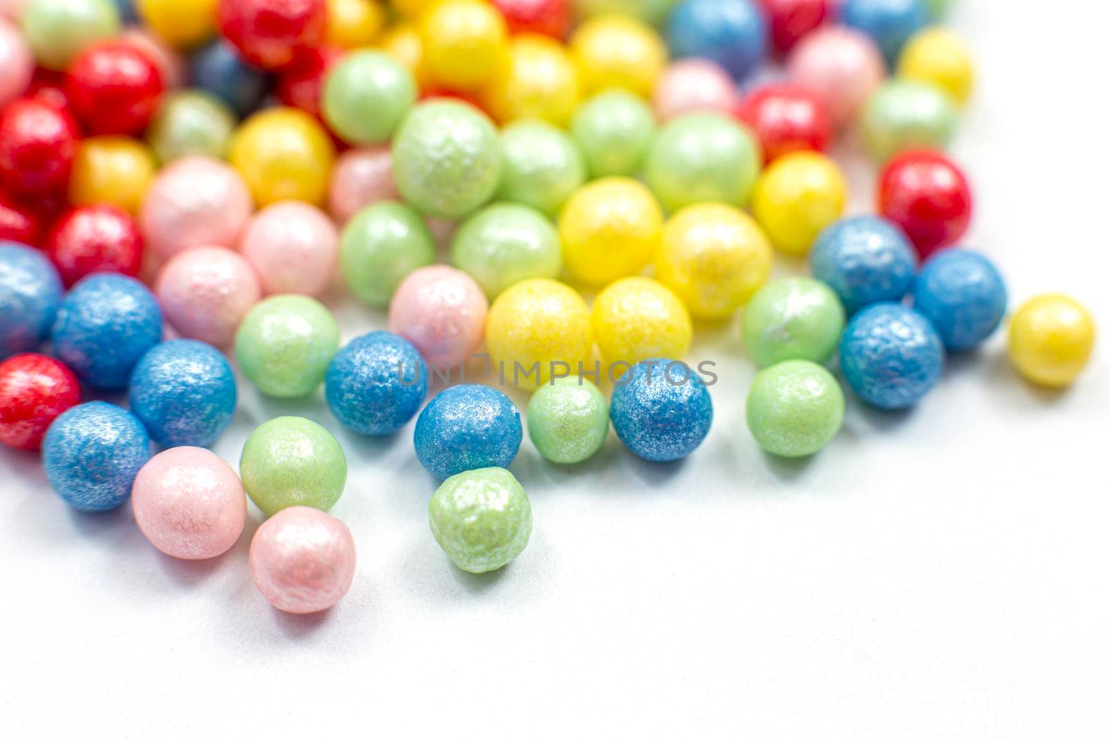 Multi-colored shiny spheres scattered on a white background by Zakharova