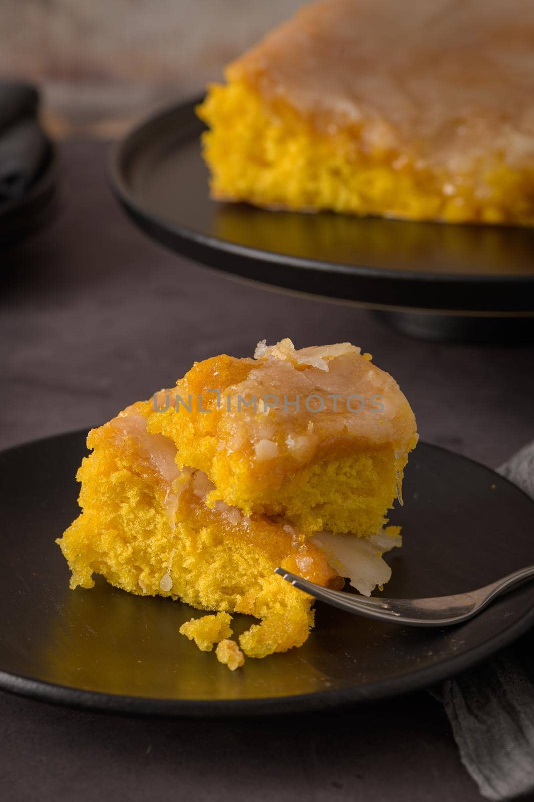 Portuguese sponge cake bolinhol from Vizela, served on a plate. On kitchen countertop.