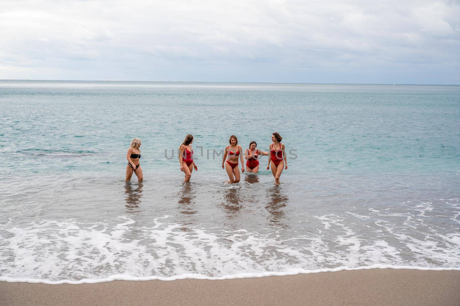 Big happy family or group of five friends is having fun against sunset beach. Beach holidays concept. by Matiunina