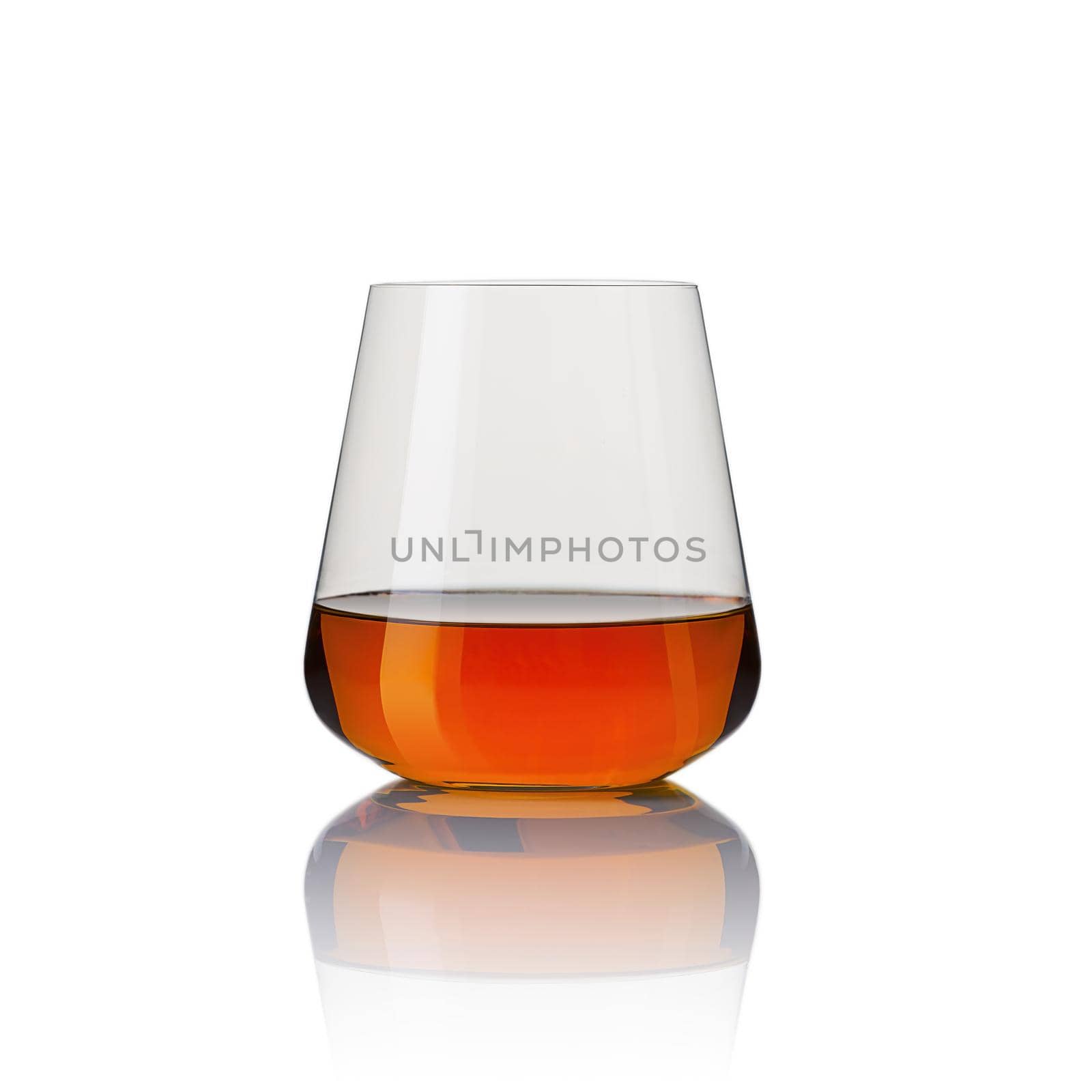 Glass of whisky - without ice and reflection, studio shot. Isolated on white