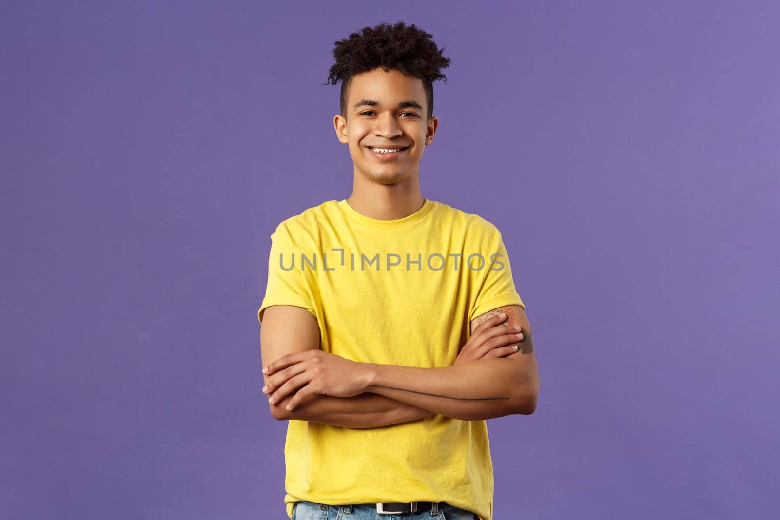 Close-up portrait of confident, smart and professional young male student with dreads, yellow t-shirt, cross arms over chest and smiling pleased, knows what he doing, purple background by Benzoix