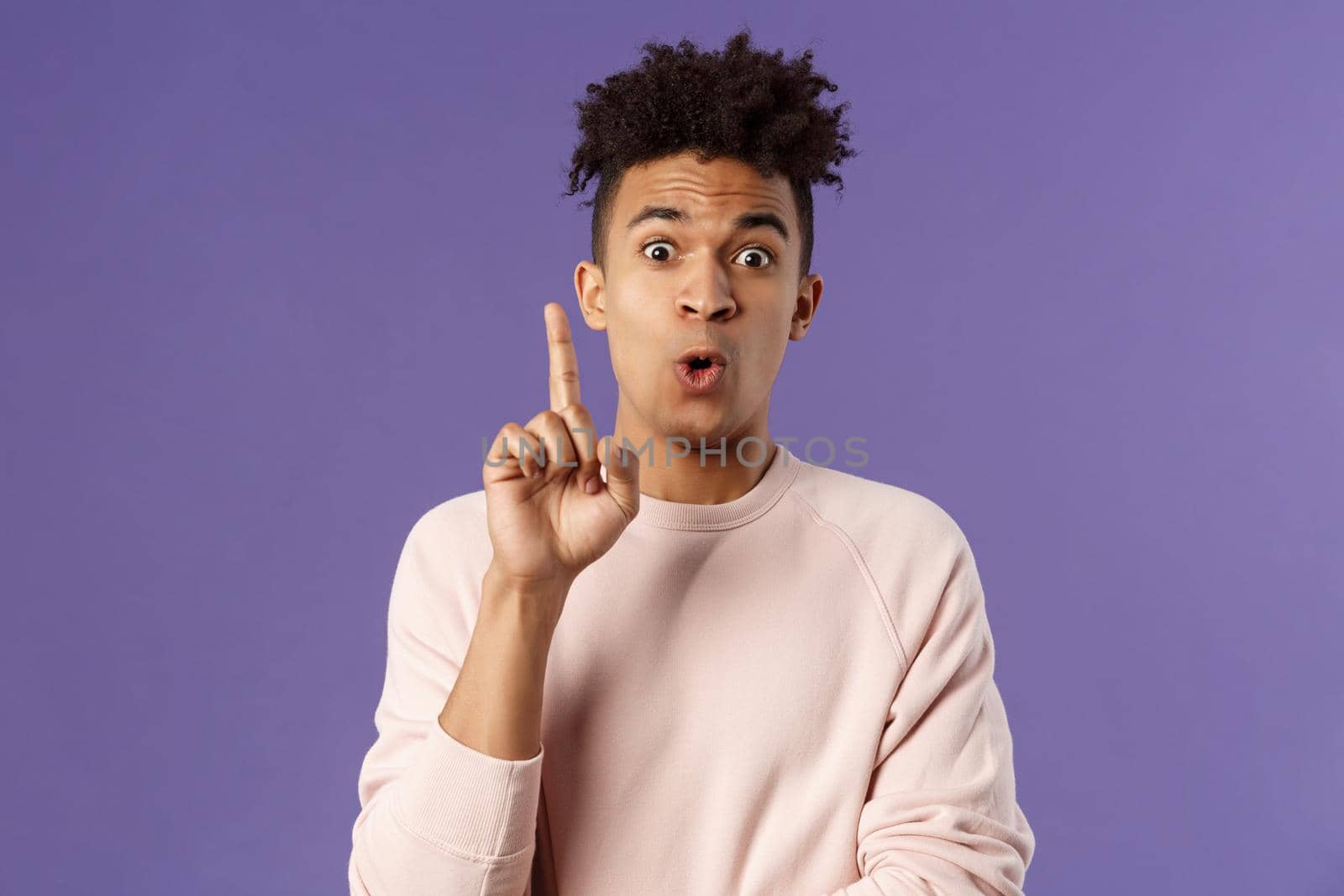 Got it, have plan. Portrait of excited happy young man, rejoicing as being striked with great idea, raise index finger in eureka gesture, figured out something, have suggestion, purple background by Benzoix