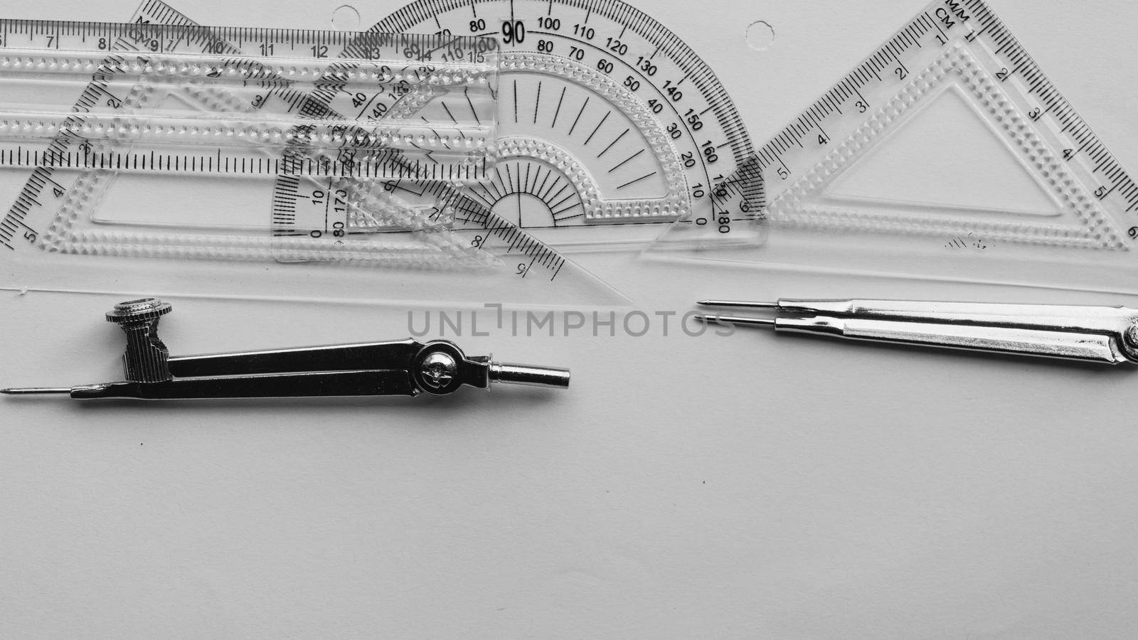 Geometric Measuring tools, Drawing items and mathematical instruments placed on white paper sheet. Back to school and Engineering education learning background. Empty Copy space room for text. by sudiptabhowmick