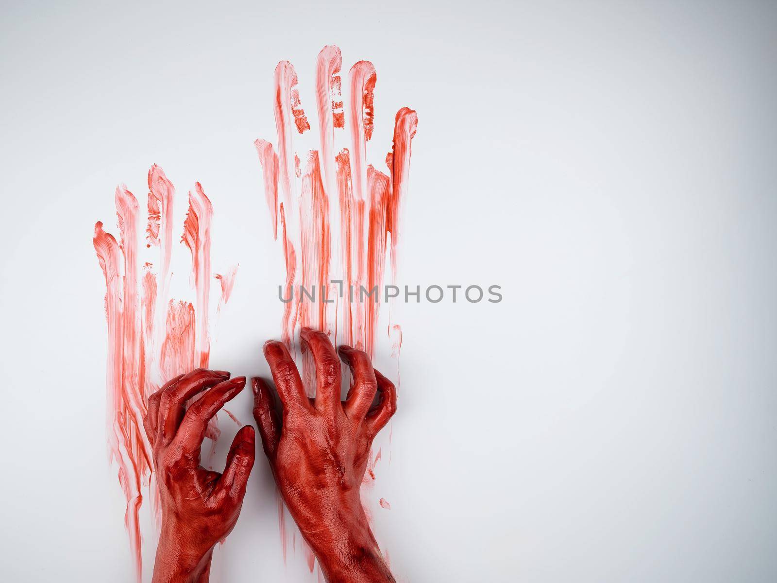 Female hands in blood on a white background