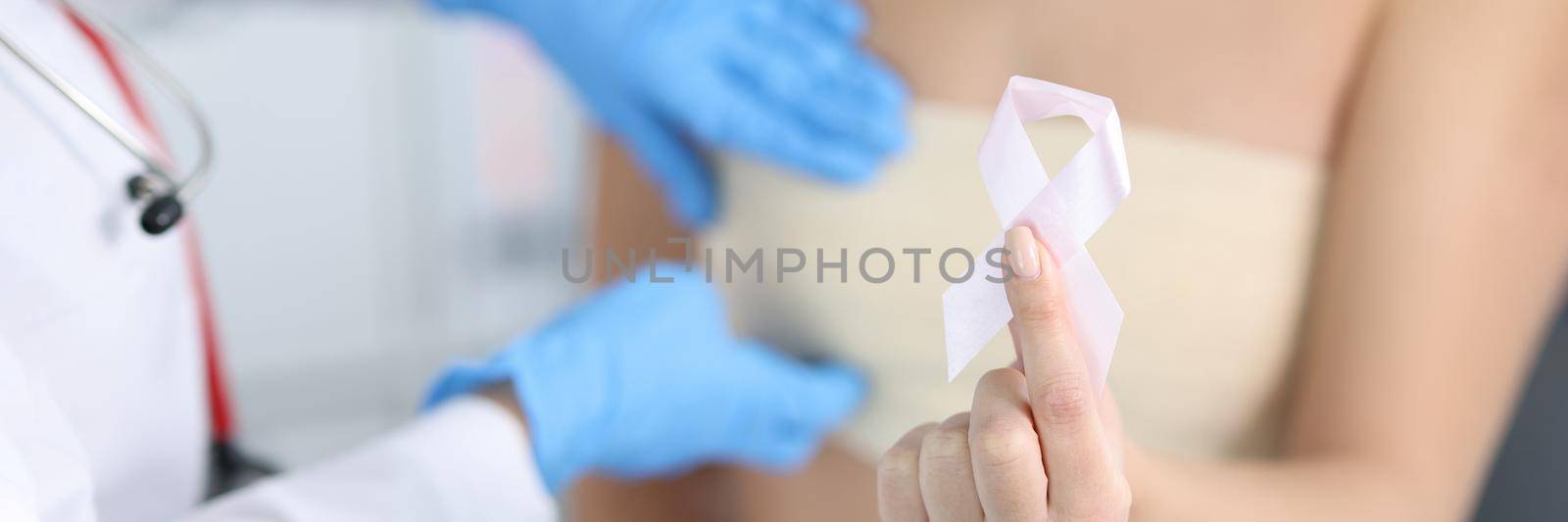 Gynecologist conducts medical examination of female breast by kuprevich