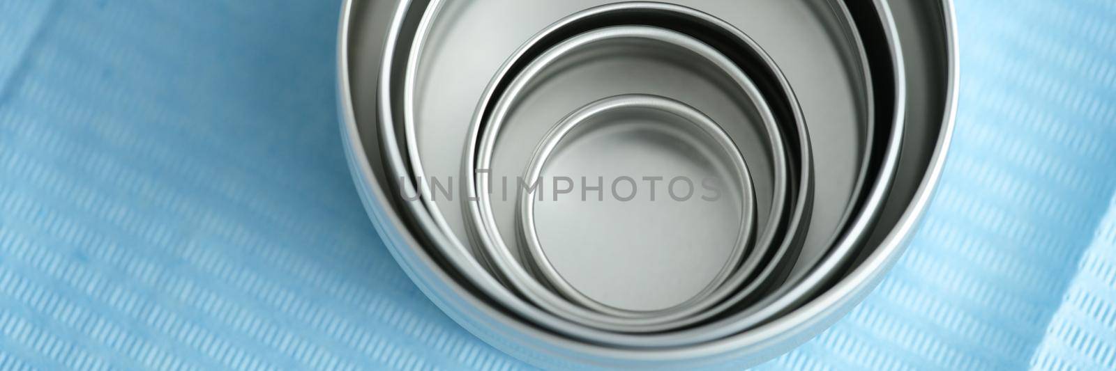 Medical and cosmetic metal jars on blue. Round cosmetic cream packaging mockup