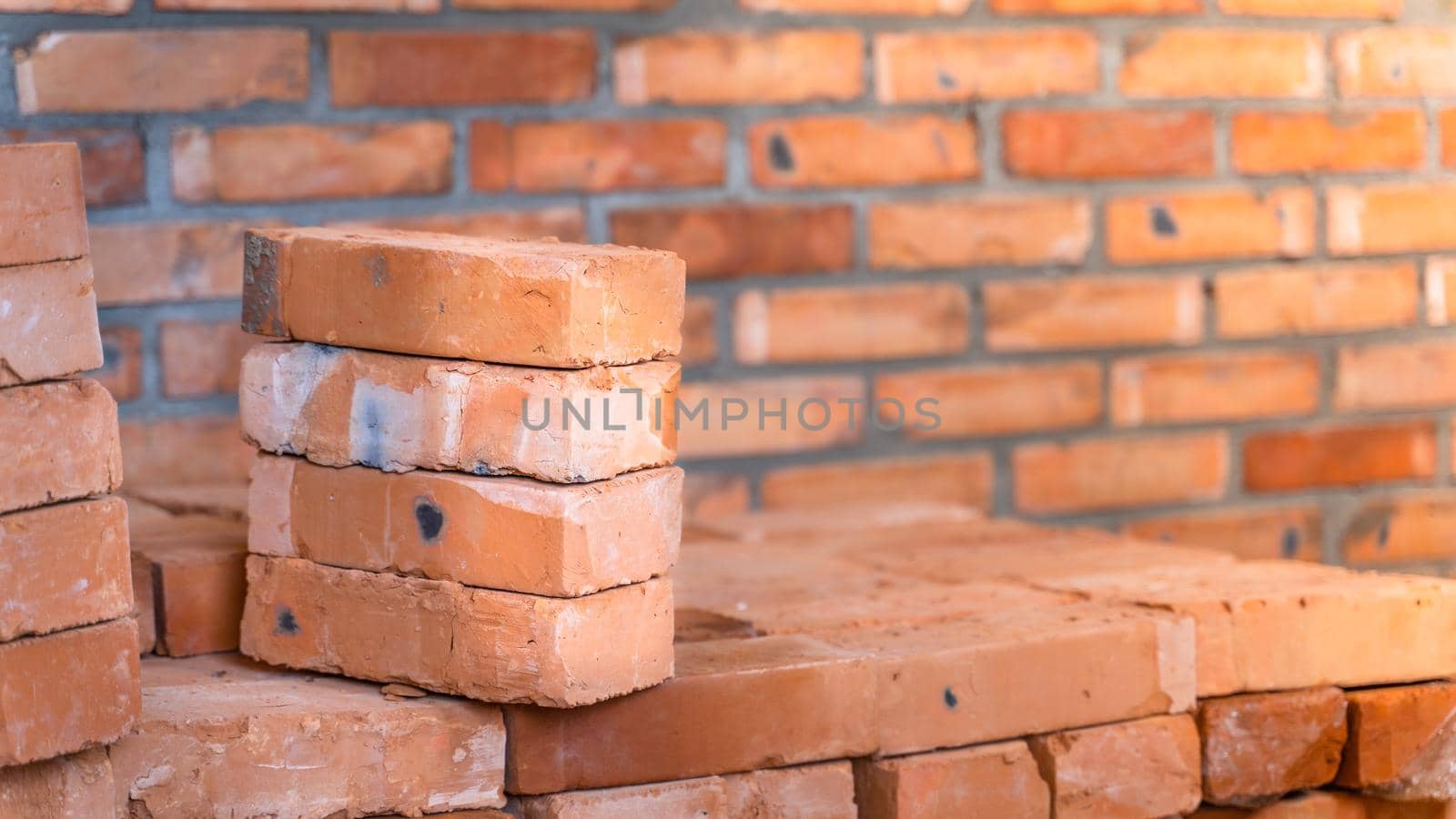 Red ceramic bricks stacked close up at a construction site. building materials