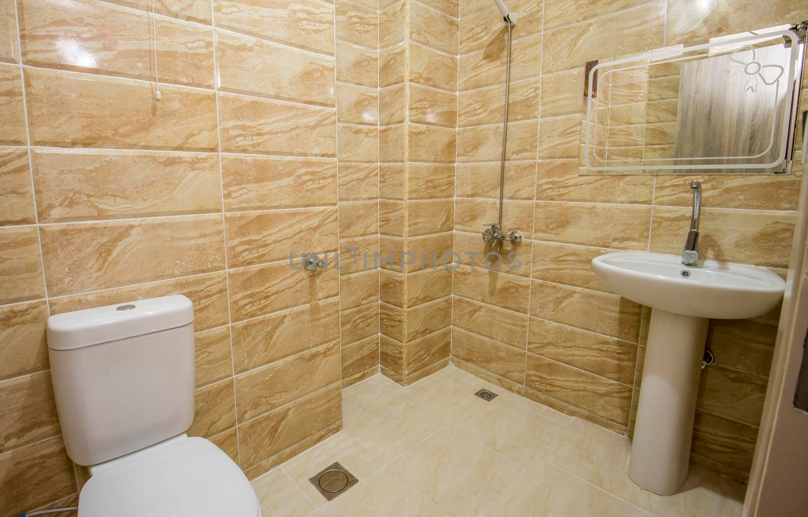 Interior design of a luxury show home bathroom with wet room shower and sink