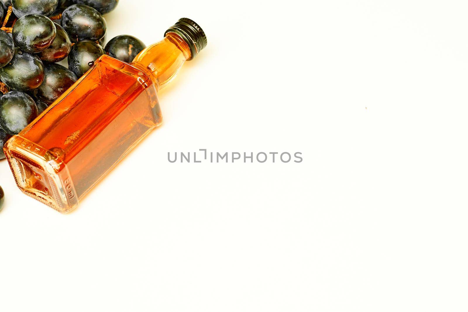 a strong or easy alcoholic spirit distilled from wine or fermented fruit juice.Good old brandy, cognac and black ripe grapes.