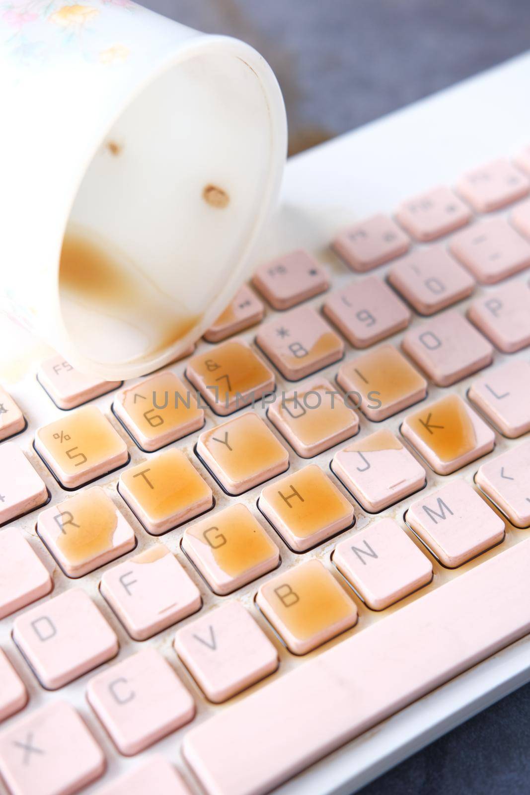 coffee spilling on laptop keyboard. close up .