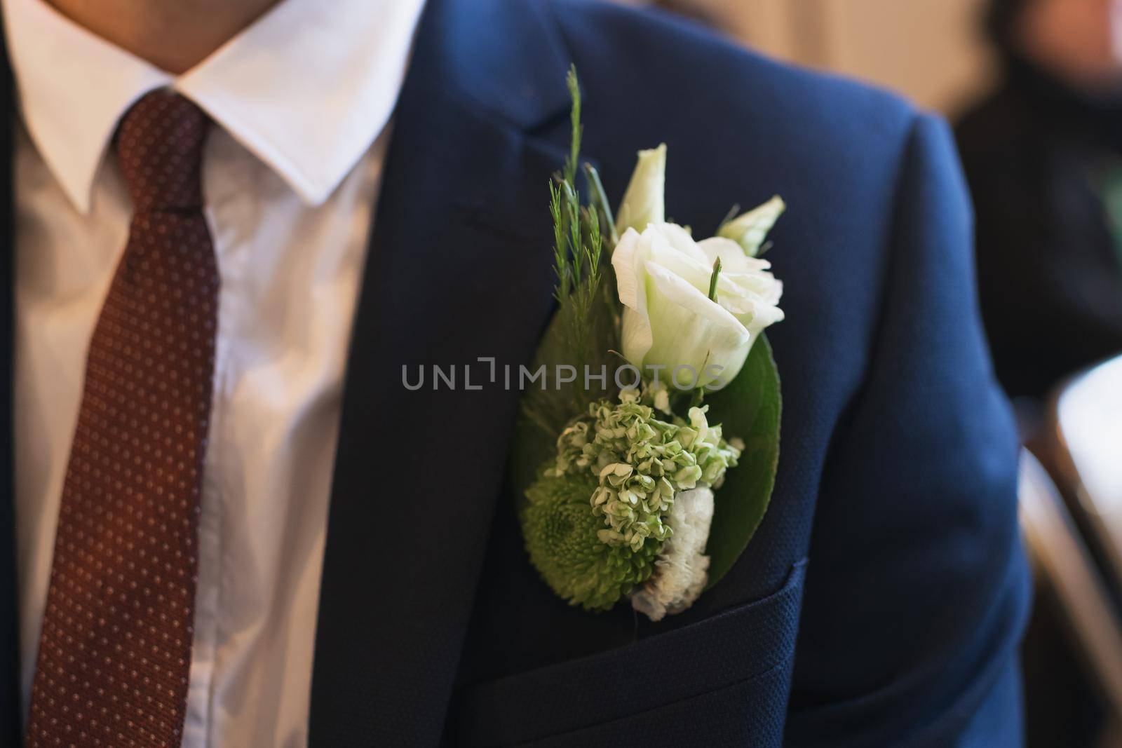 Groom with a boutonniere of white eustoma