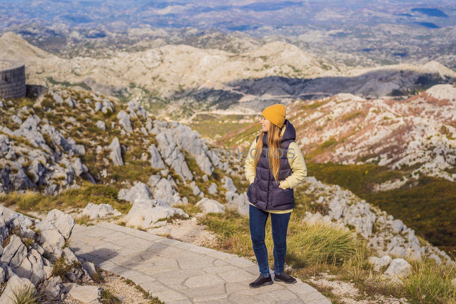 Woman traveller in mountain landscape at national park Lovcen, Montenegro. Travel to Montenegro concept.