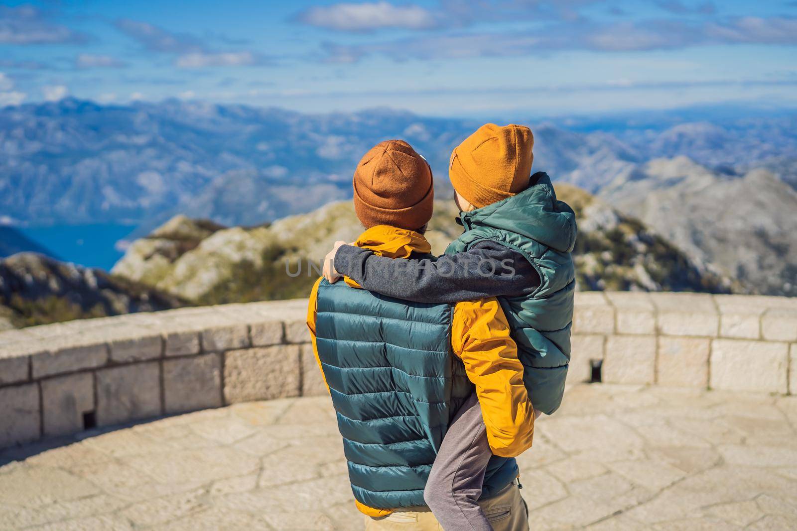 Dad and son travellers in mountain landscape at national park Lovcen, Montenegro. Travel to Montenegro with children concept.