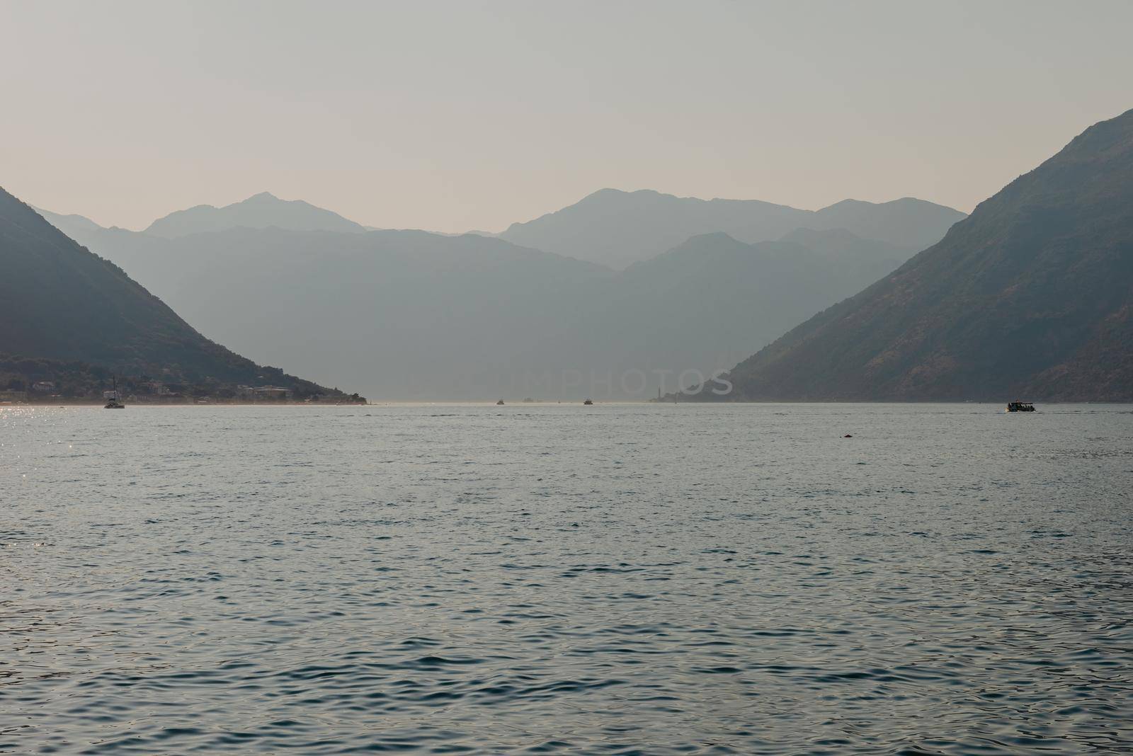 Sunset, beautiful landscape with silhouettes of trees. Travel concept. Montenegro, Kotor Bay. Sunset at Kotor Bay Montenegro. View of the sunset in Boko-Kotor Bay in Montenegro. Silhouettes of mountains. High quality photo