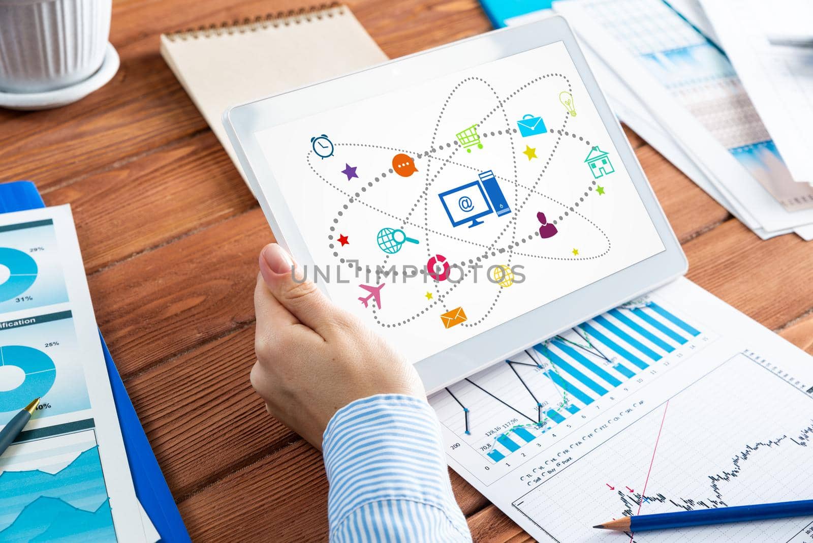 close-up, female hands with tablet. Business woman working at the table in the office