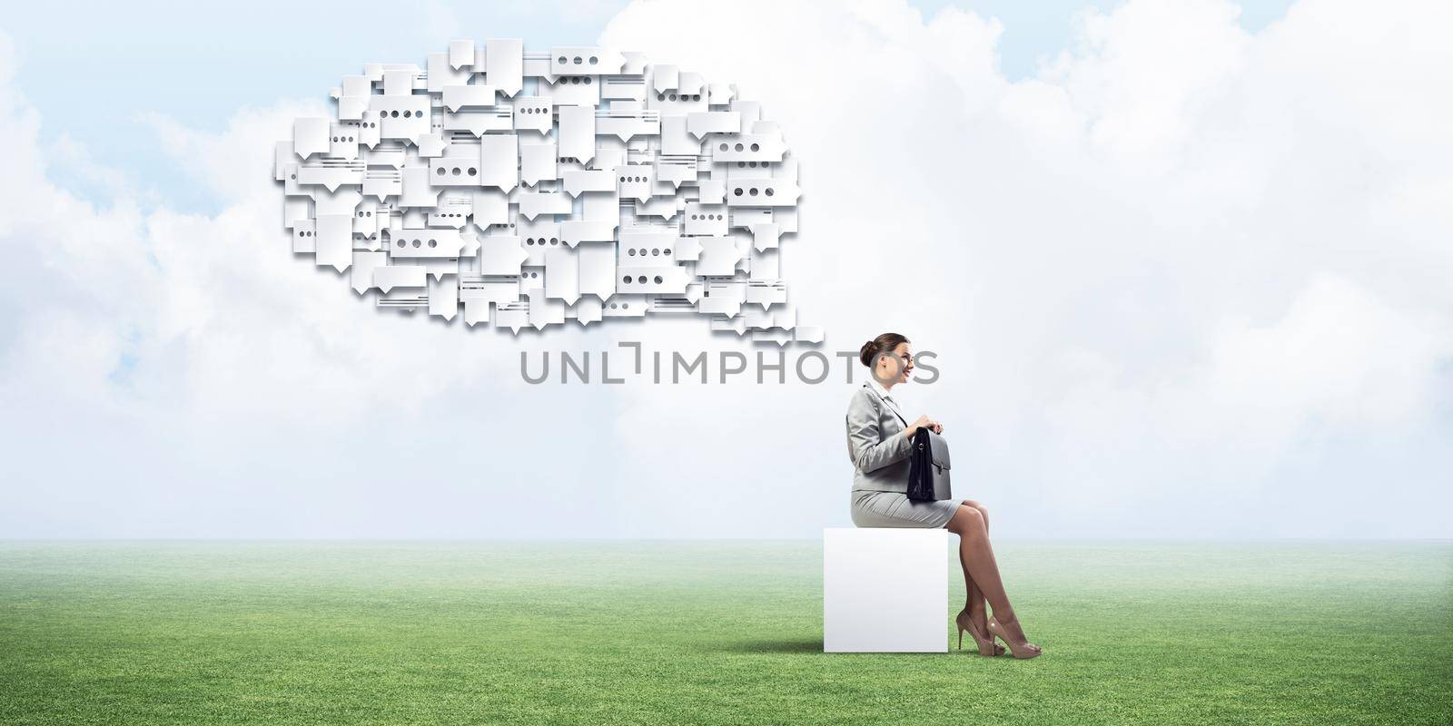 Elegant businesswoman with suitcase in hand sitting on white cube and many chat icons