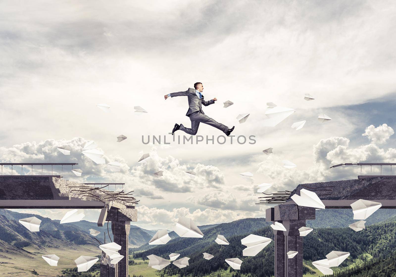 Businessman jumping over gap in bridge among flying paper planes as symbol of overcoming challenges. Skyscape and nature view on background. 3D rendering.