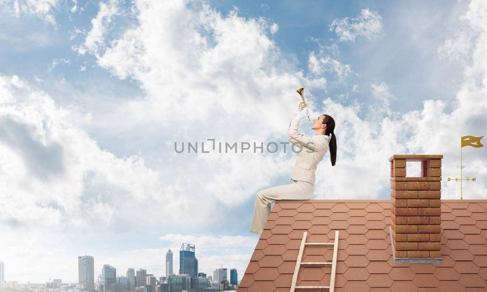 Elegant young woman playing trumpet on edge of roof. Girl in white business suit and gloves with music brass instrument posing on roof of building. Blue sky and modern metropolis with skyscrapers.