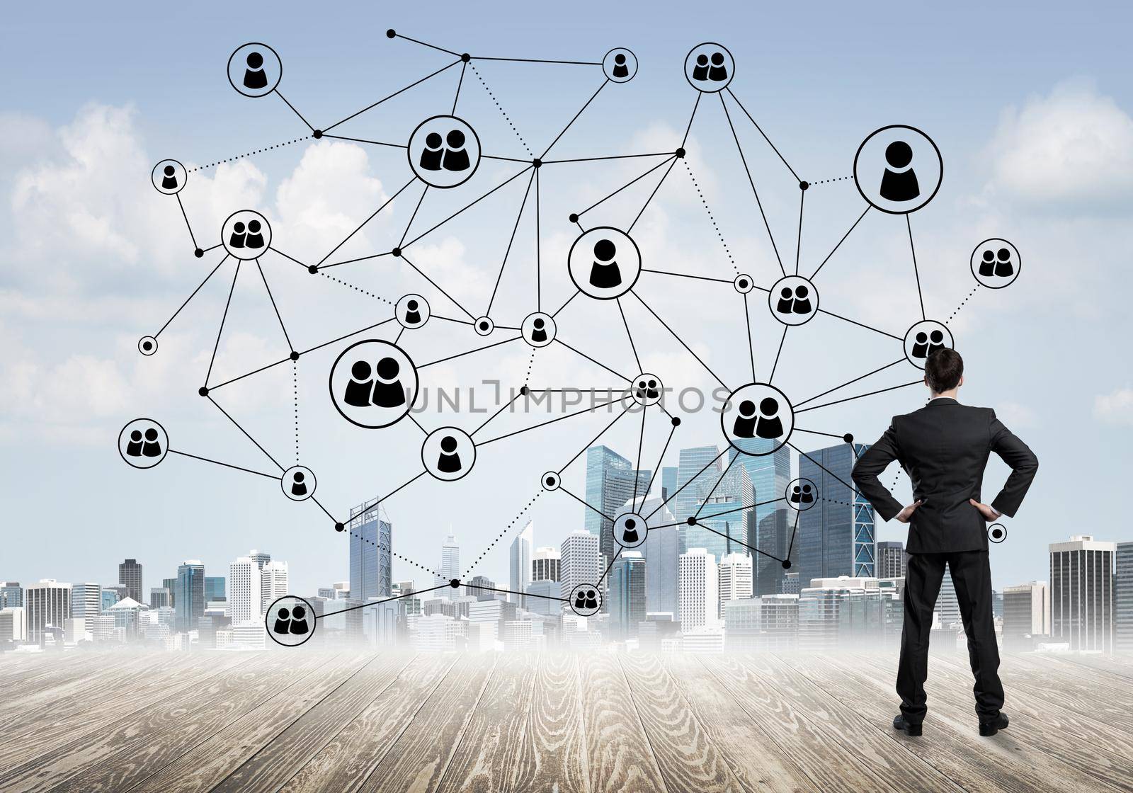 Back view of businessman looking at modern cityscape and connection concept
