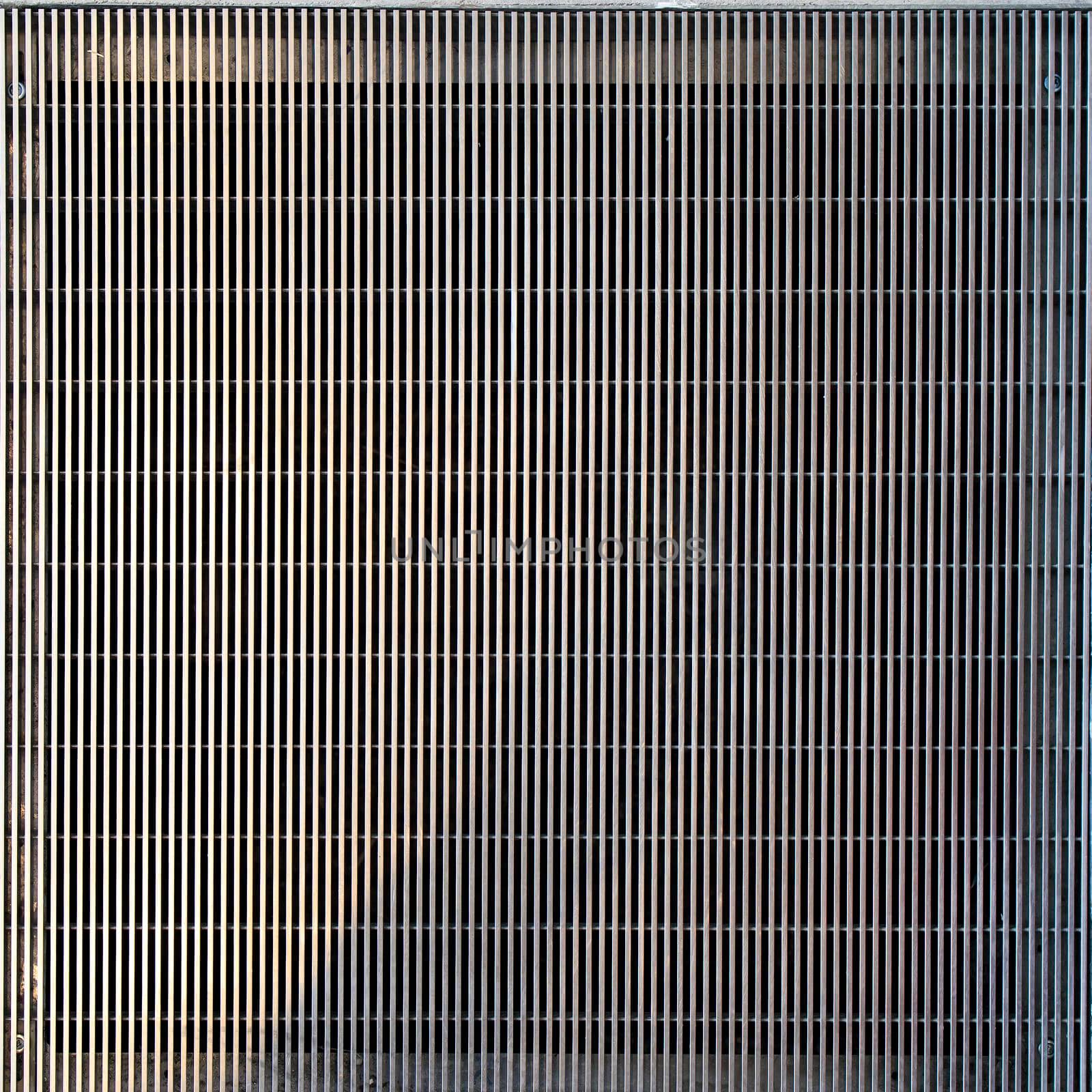 Fragment of a modern ventilation grill in a concrete floor by elenarostunova