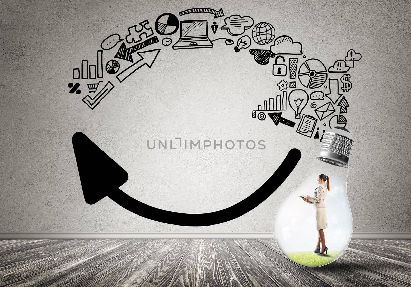 Businesswoman inside of light bulb in empty concrete room