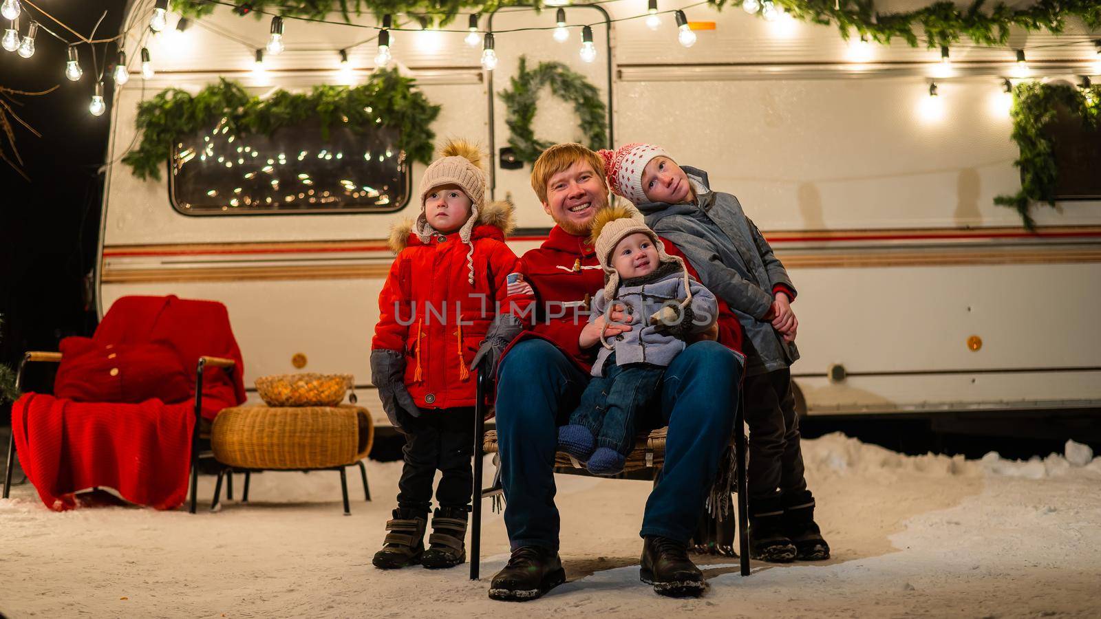 Caucasian man and three sons celebrate Christmas in a mobile home. by mrwed54
