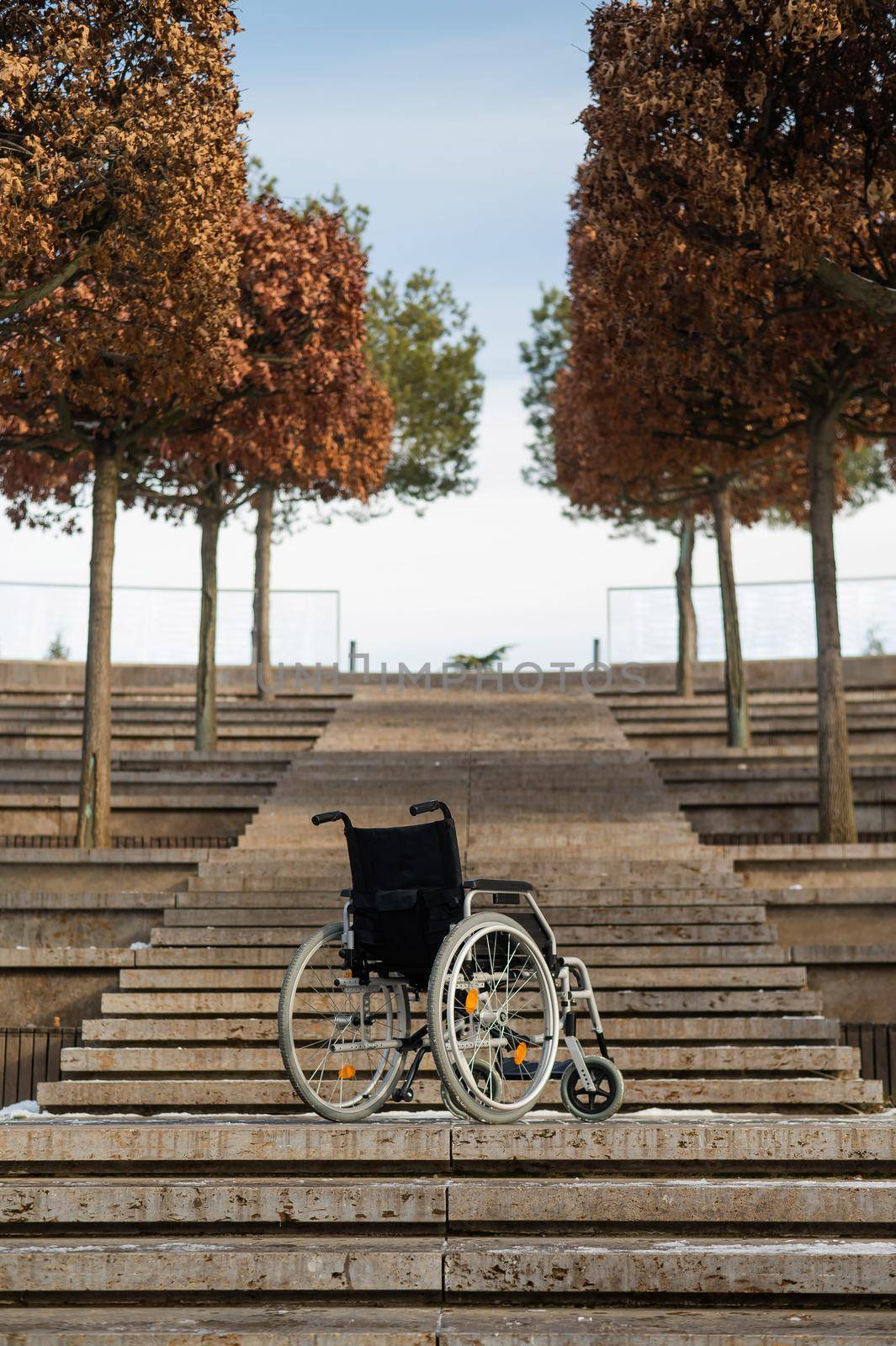 Wheelchair by the stairs without people outdoors