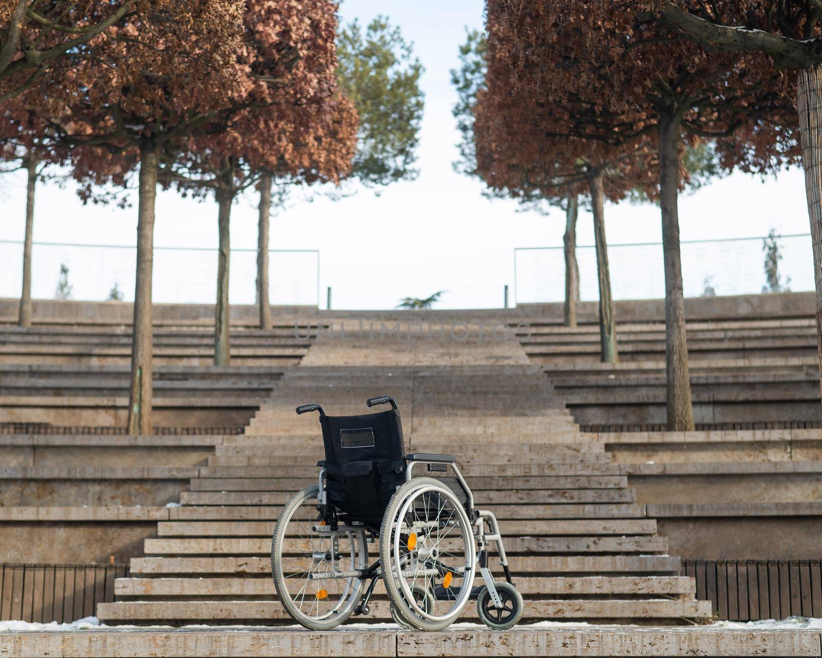 Wheelchair by the stairs without people outdoors. by mrwed54