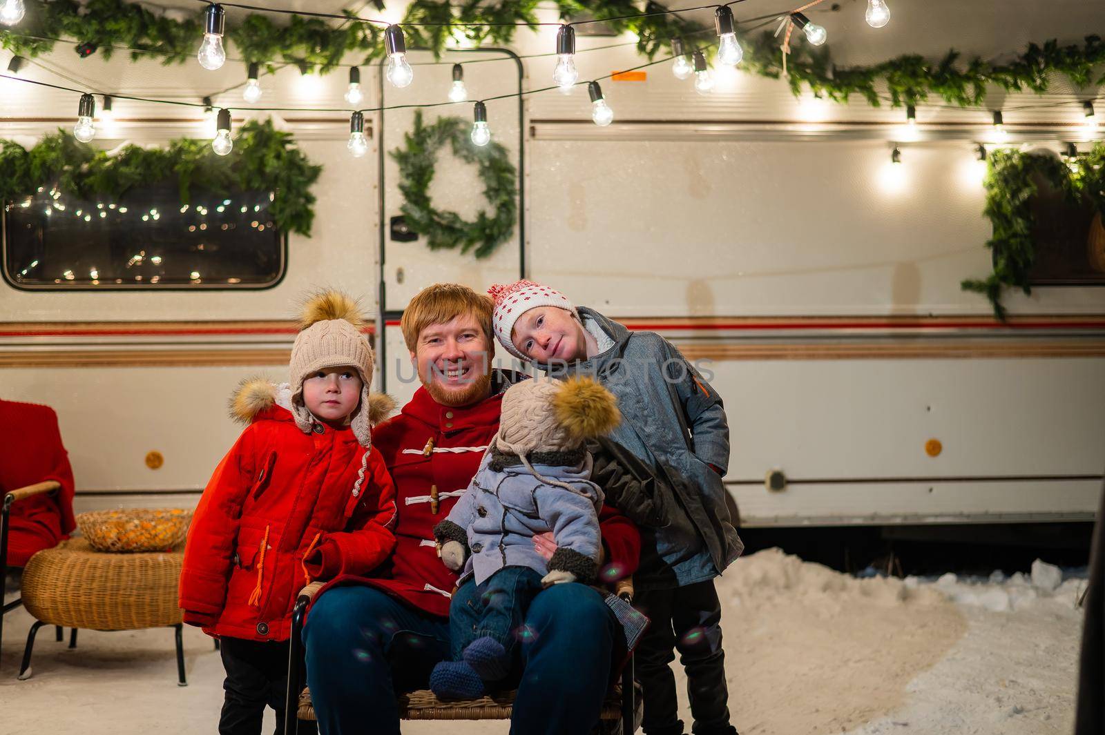 Caucasian man and three sons celebrate Christmas in a mobile home. by mrwed54