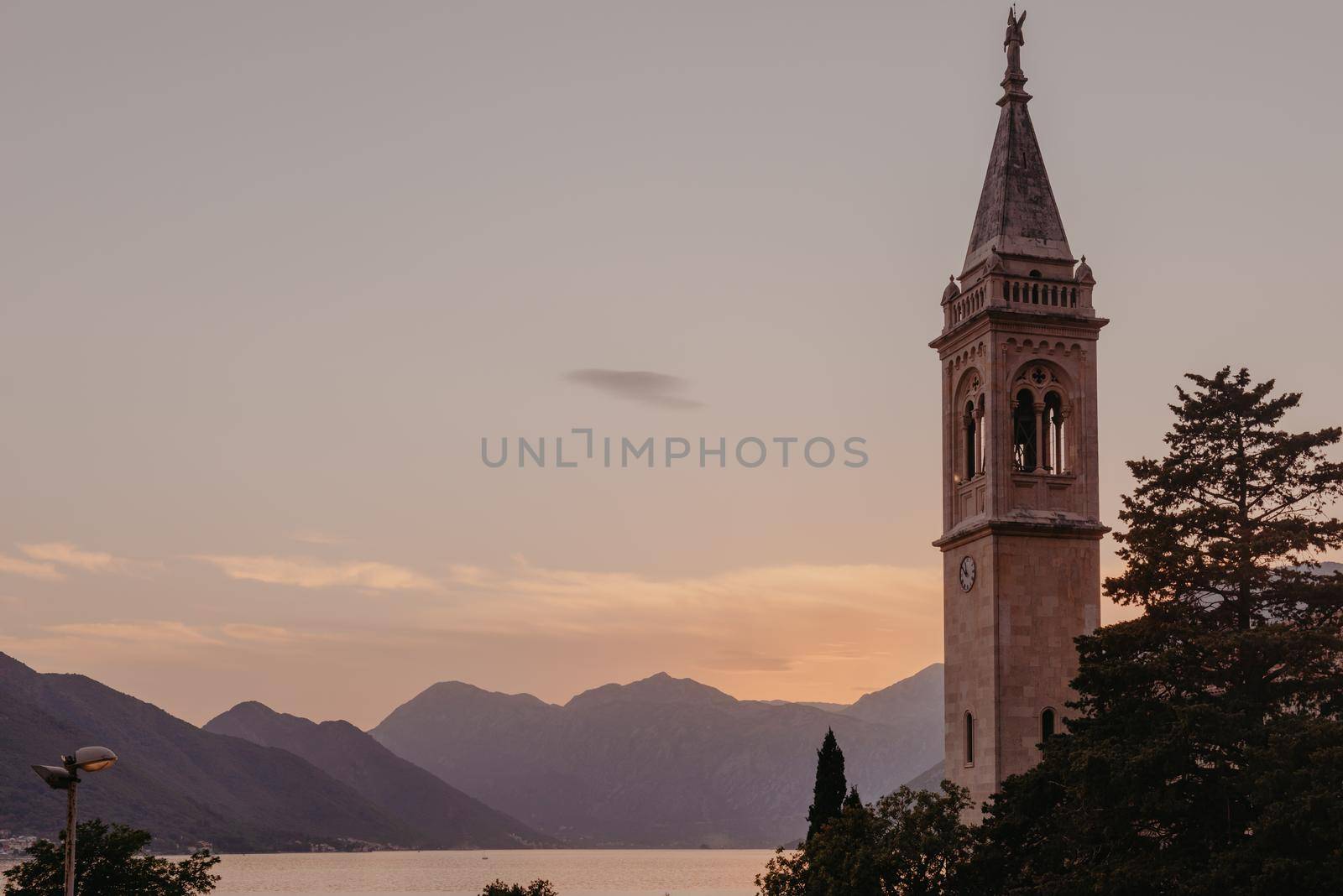 Beautiful Sunset view of the coast of Kotor Bay and St.Eustace's Church in the village Dobrota in Montenegro. Church of St. Eustachius is located in Dobrota , Kotor Montenegro. by Andrii_Ko