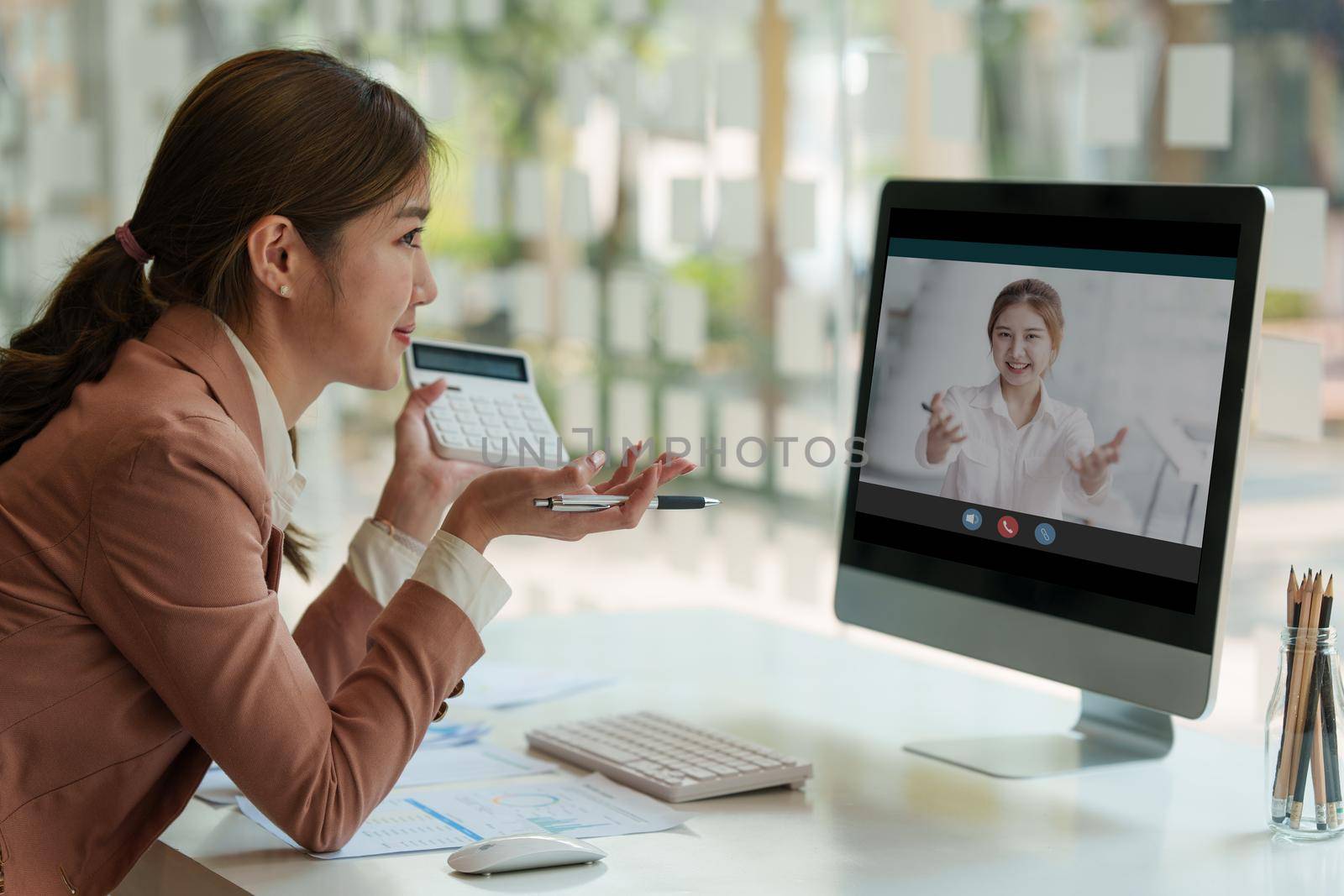 Modern Asian Business woman have confident working with financial team by video conference at office. Accounting concept. by itchaznong