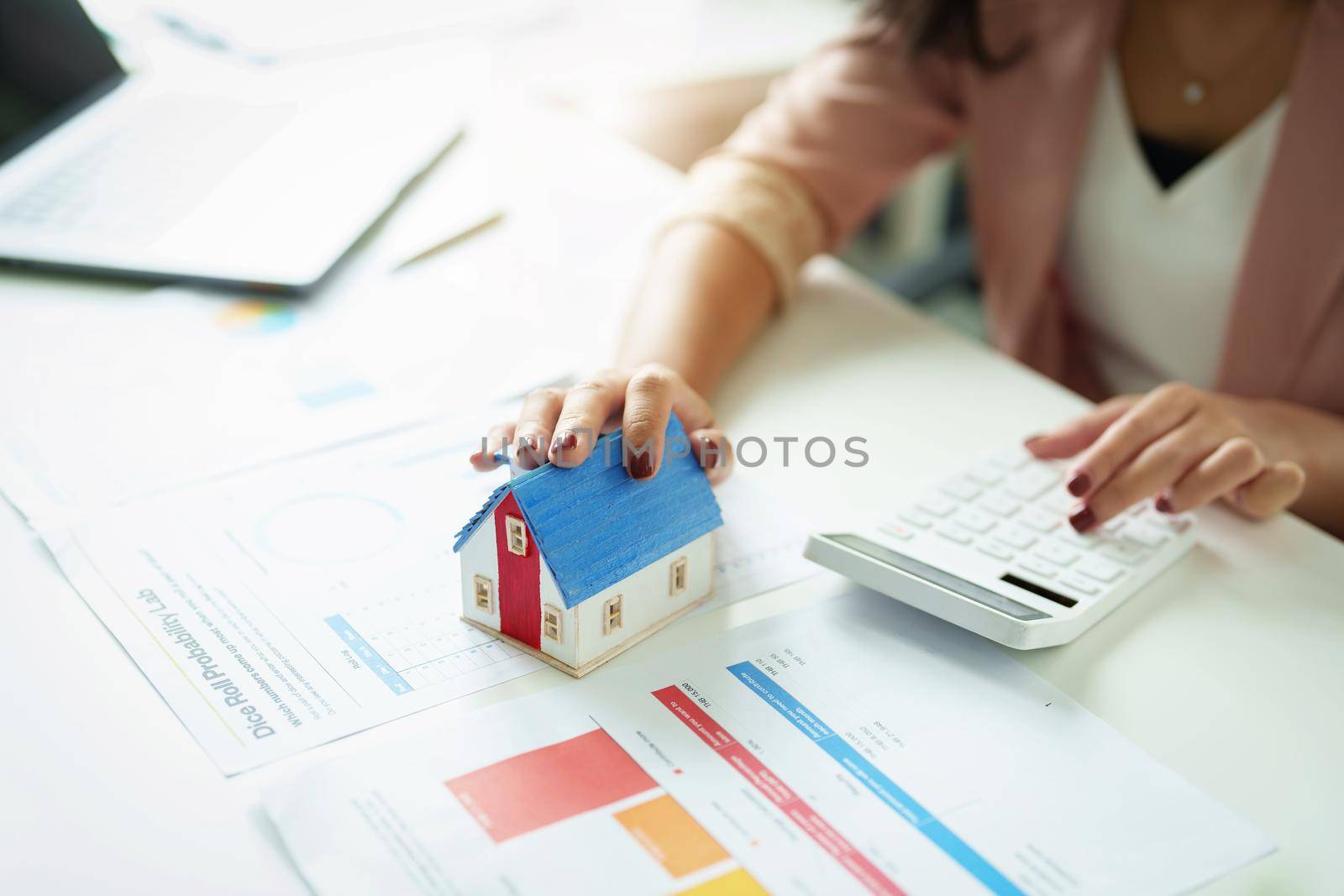 agents, land purchases and sales, property taxes,focus model house with real estate owners are using calculators to calculate home and land tax expenditures to manage financial and investment risks. by Manastrong