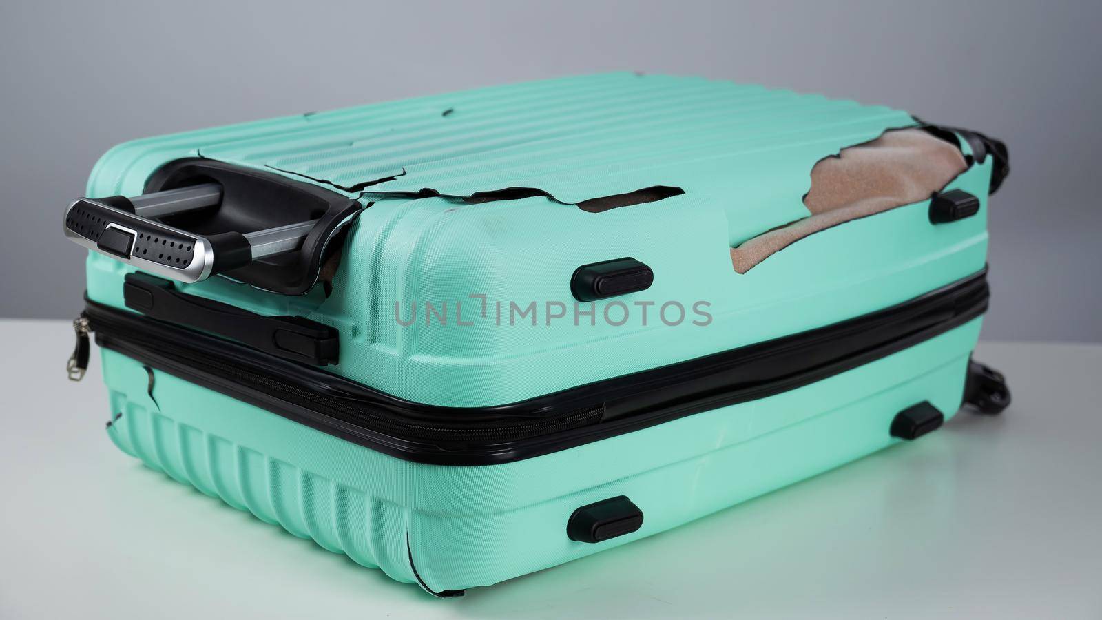 Broken plastic mint suitcase on a white background. by mrwed54