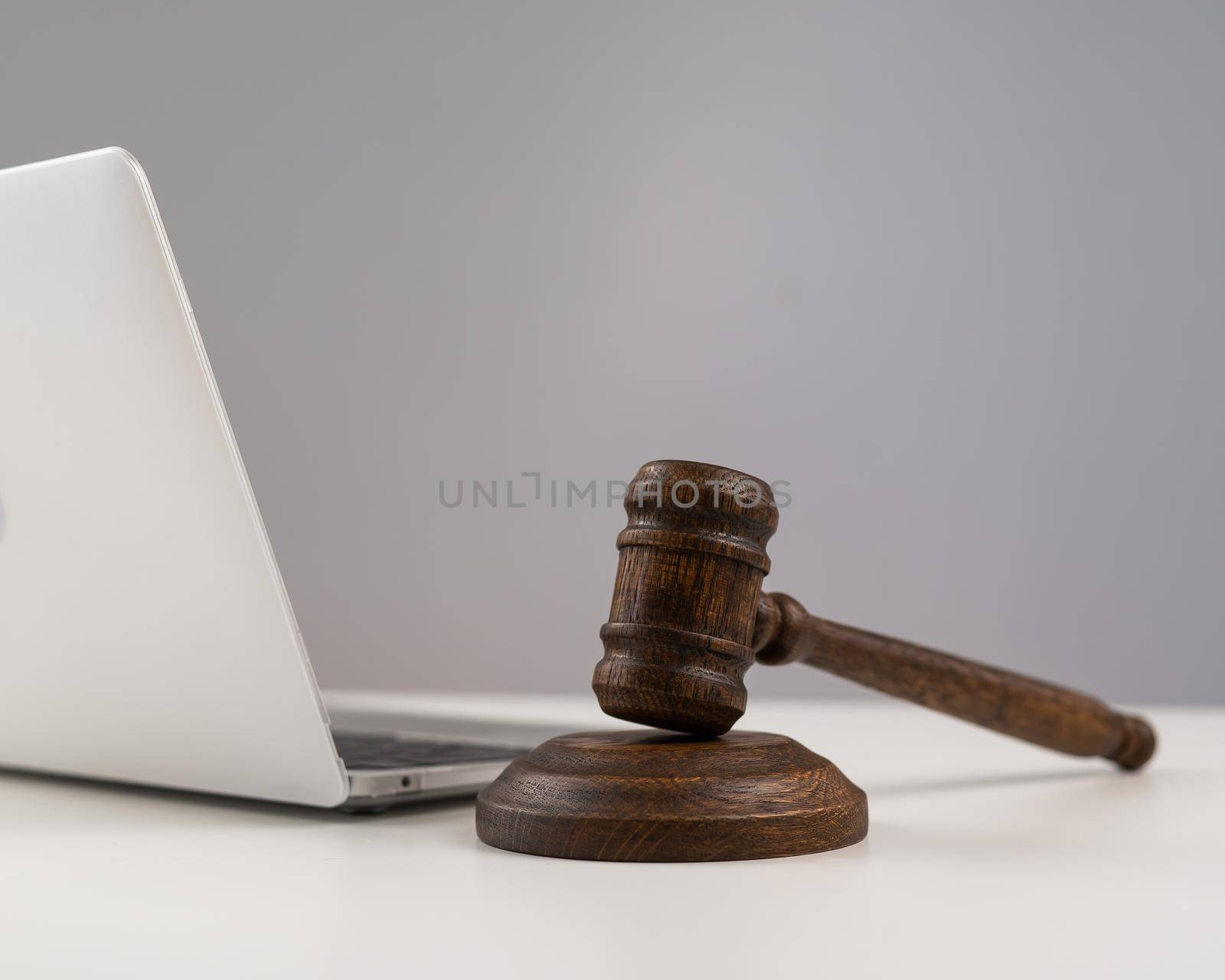 Judicial gavel and laptop on white background