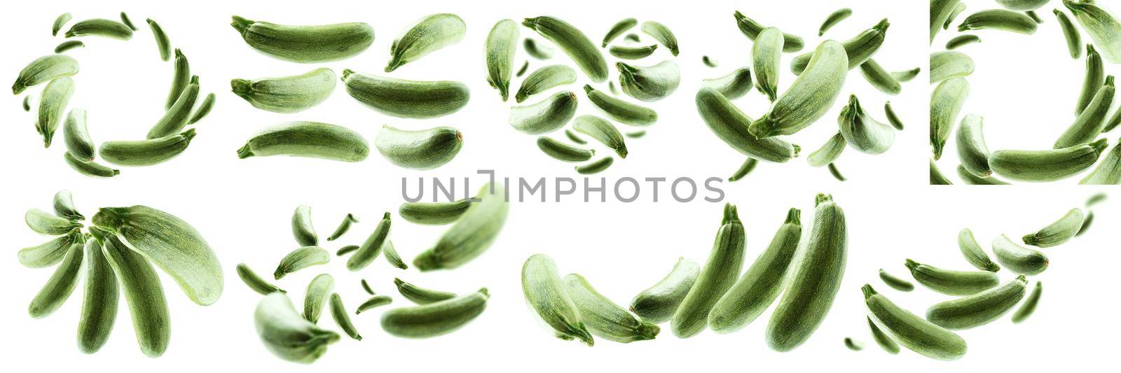 A set of photos. Green zucchini levitate on a white background.